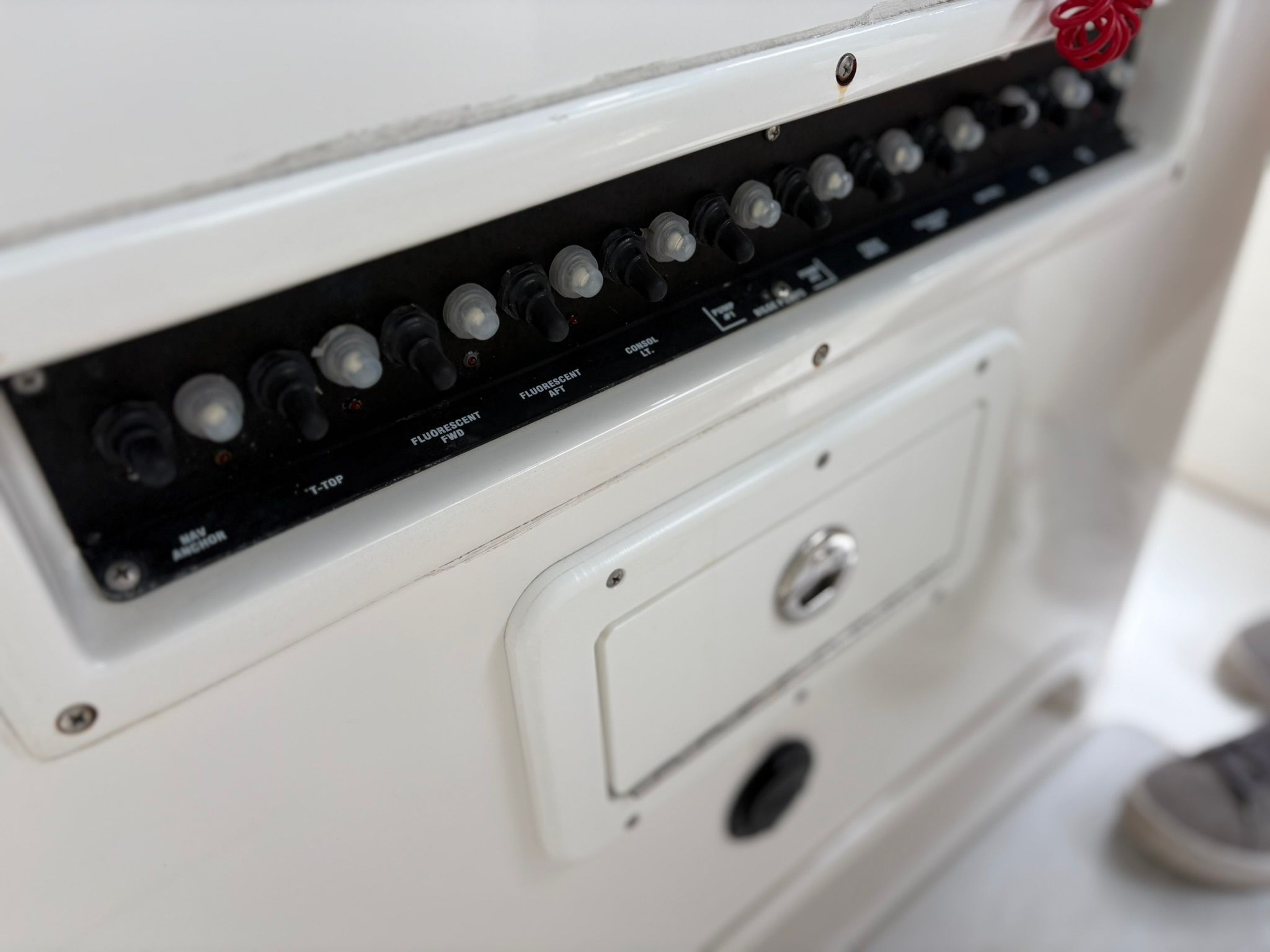 Close-up of a boat control panel with multiple switches and knobs.