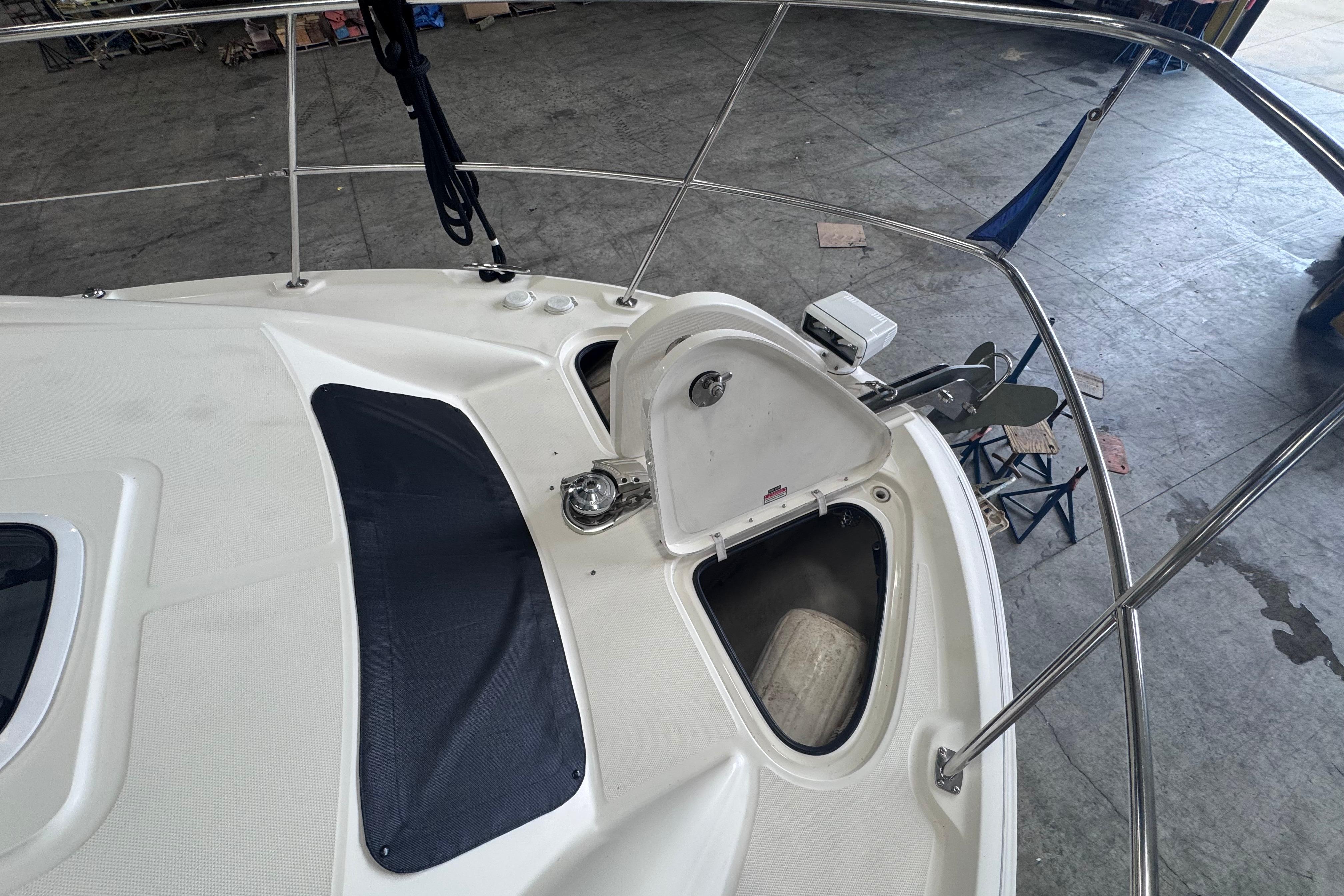 2004 Sea Ray 390 Motor Yacht bow with open anchor locker in a marina setting.