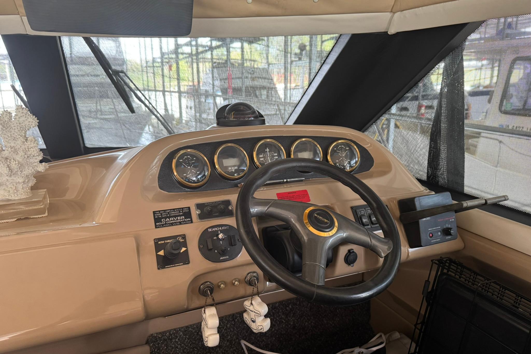 1999 Carver 450 Voyager Pilothouse helm with steering wheel and instrument panel.