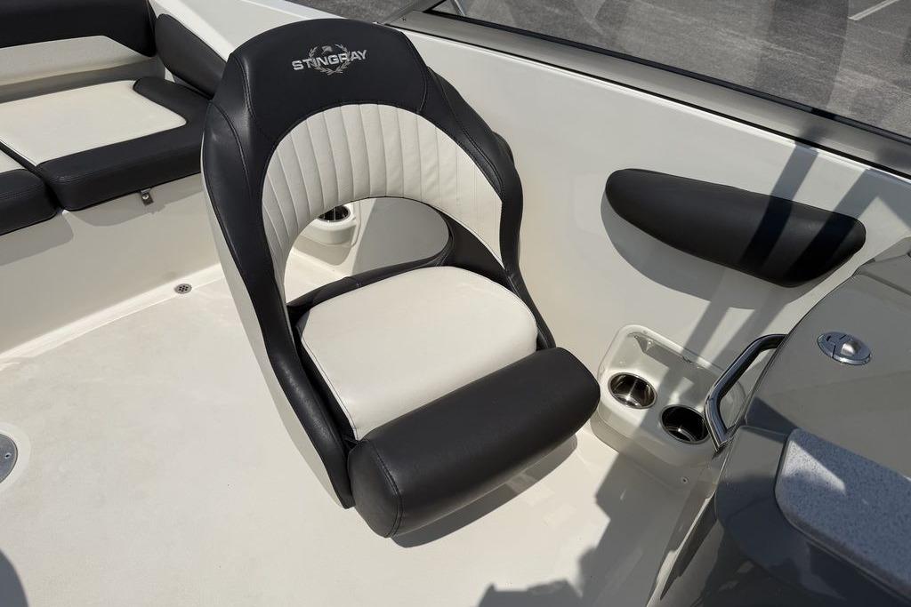 2019 Stingray 201 DS boat interior with black and white seating and cup holders.