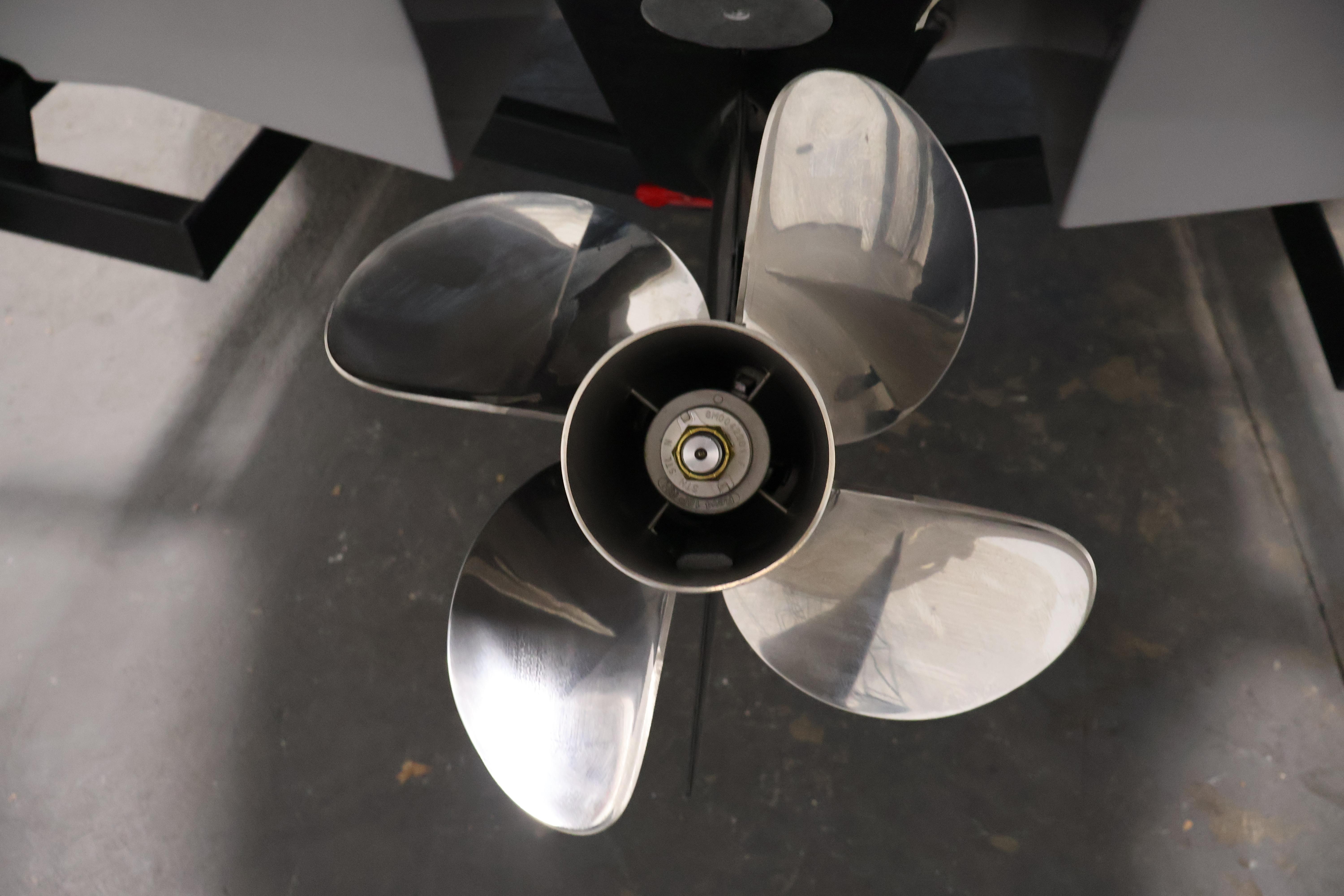 2026 Four Winns H4 Freedom boat propeller, close-up view in a garage setting.
