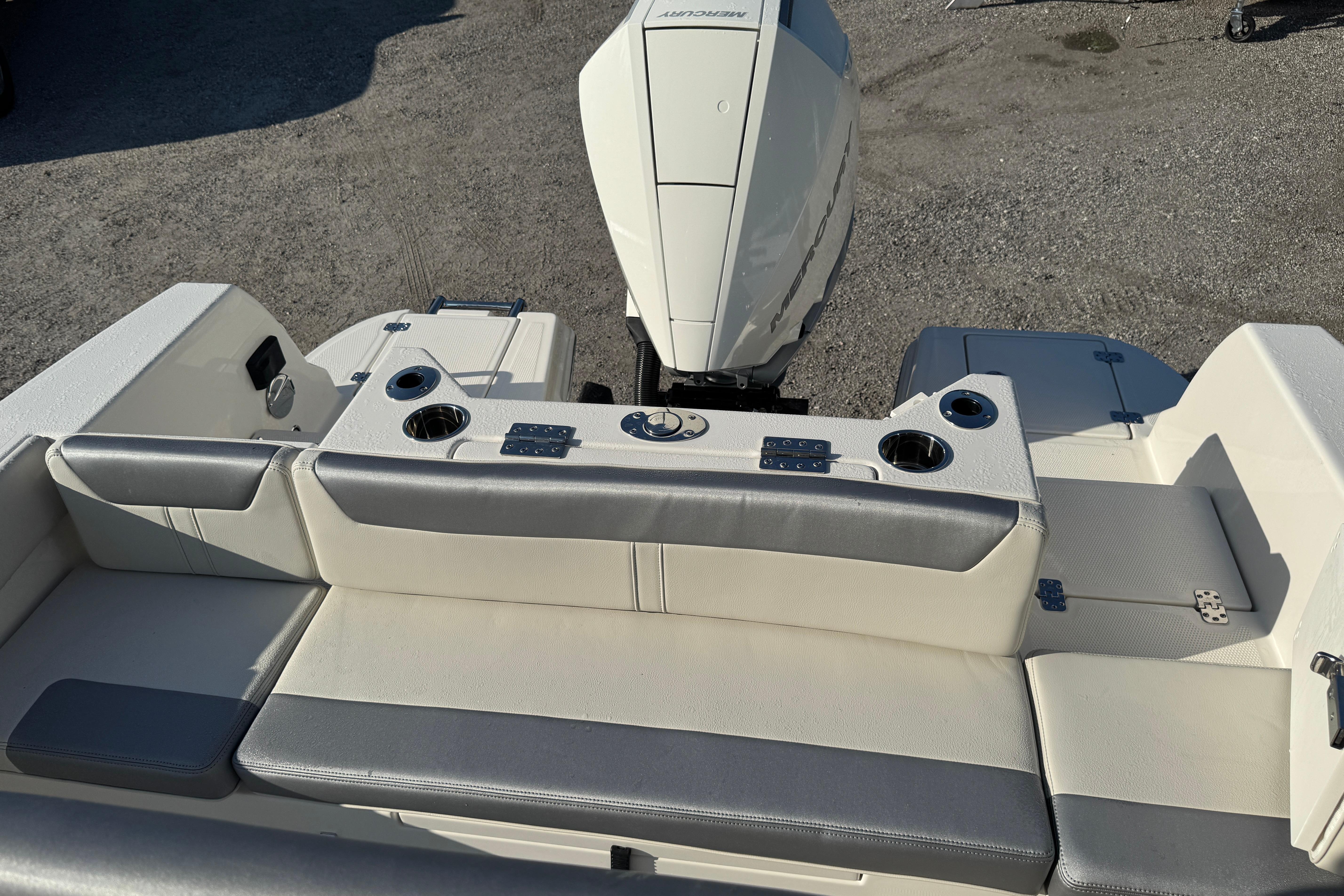 2026 Sailfish 232 CC boat interior with seating and motor, featuring cup holders.