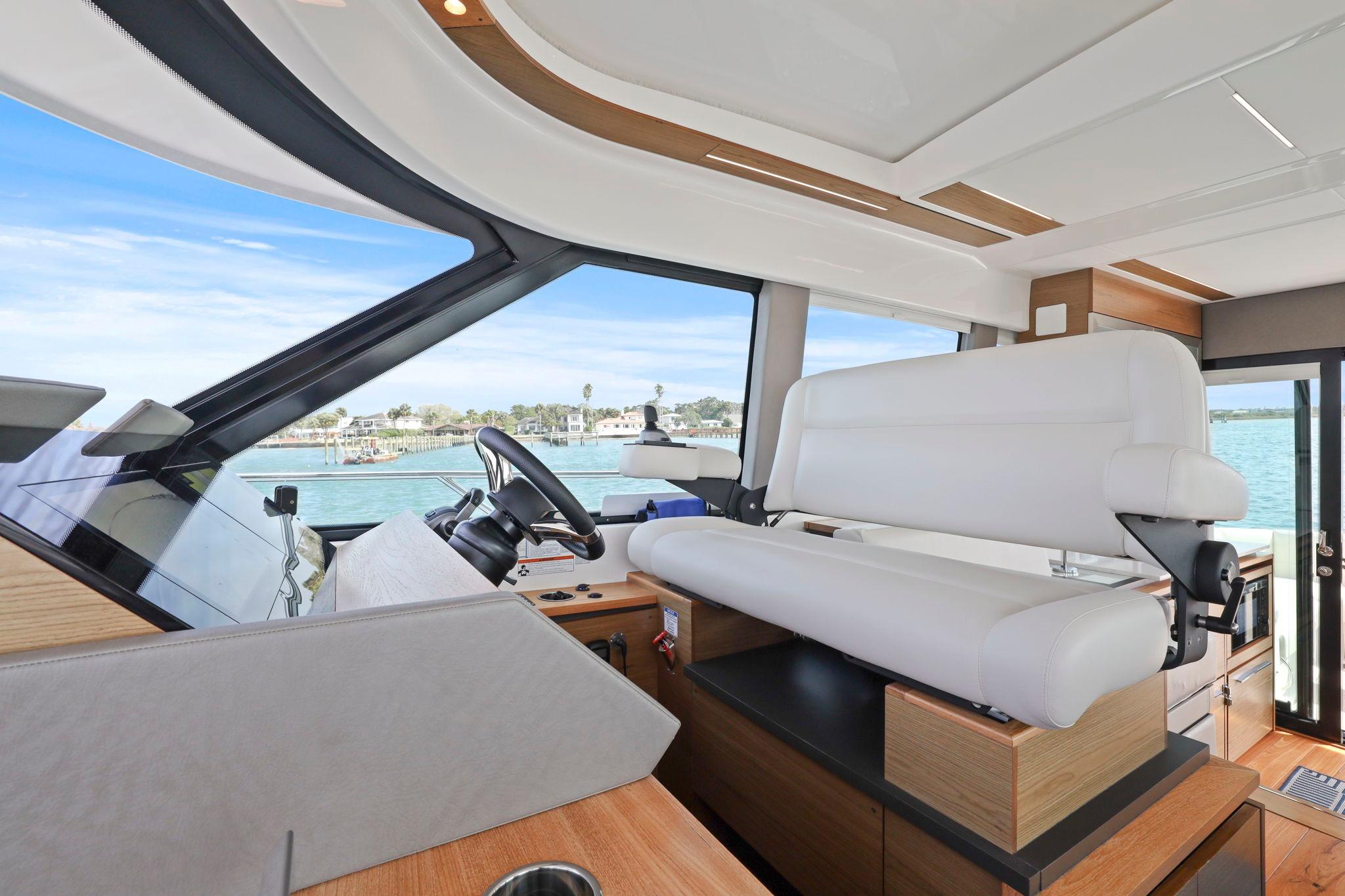 2023 Tiara Yachts C49 Coupe interior with modern helm and panoramic windows.
