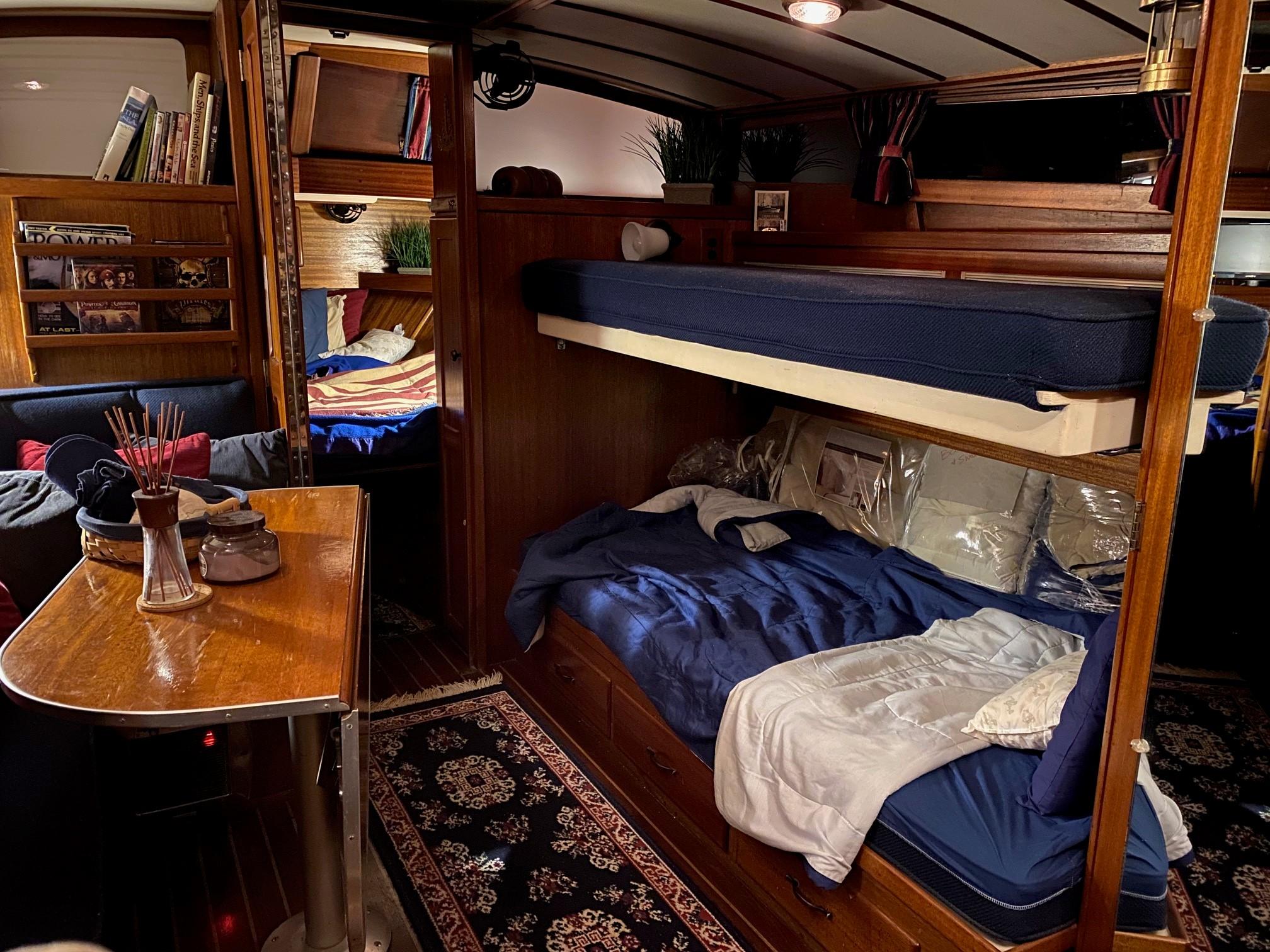 Interior of a 1964 Egg Harbor 37 Convertible Sedan with cozy bunk beds and wooden furnishings.