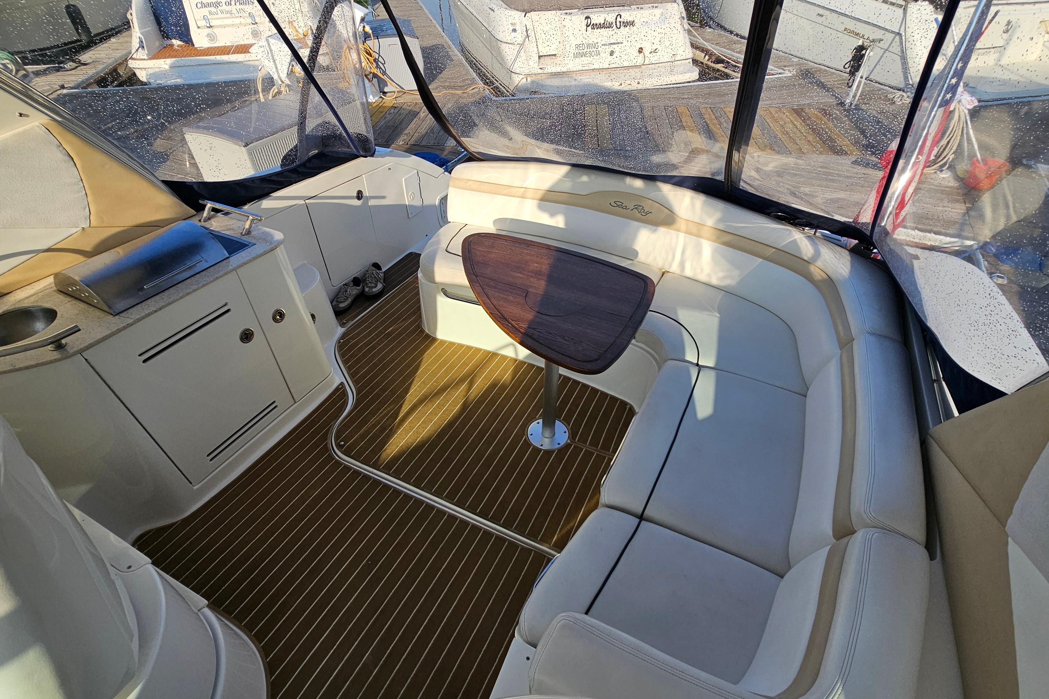Interior of 2008 Sea Ray Sundancer 350 with seating, table, and kitchenette.
