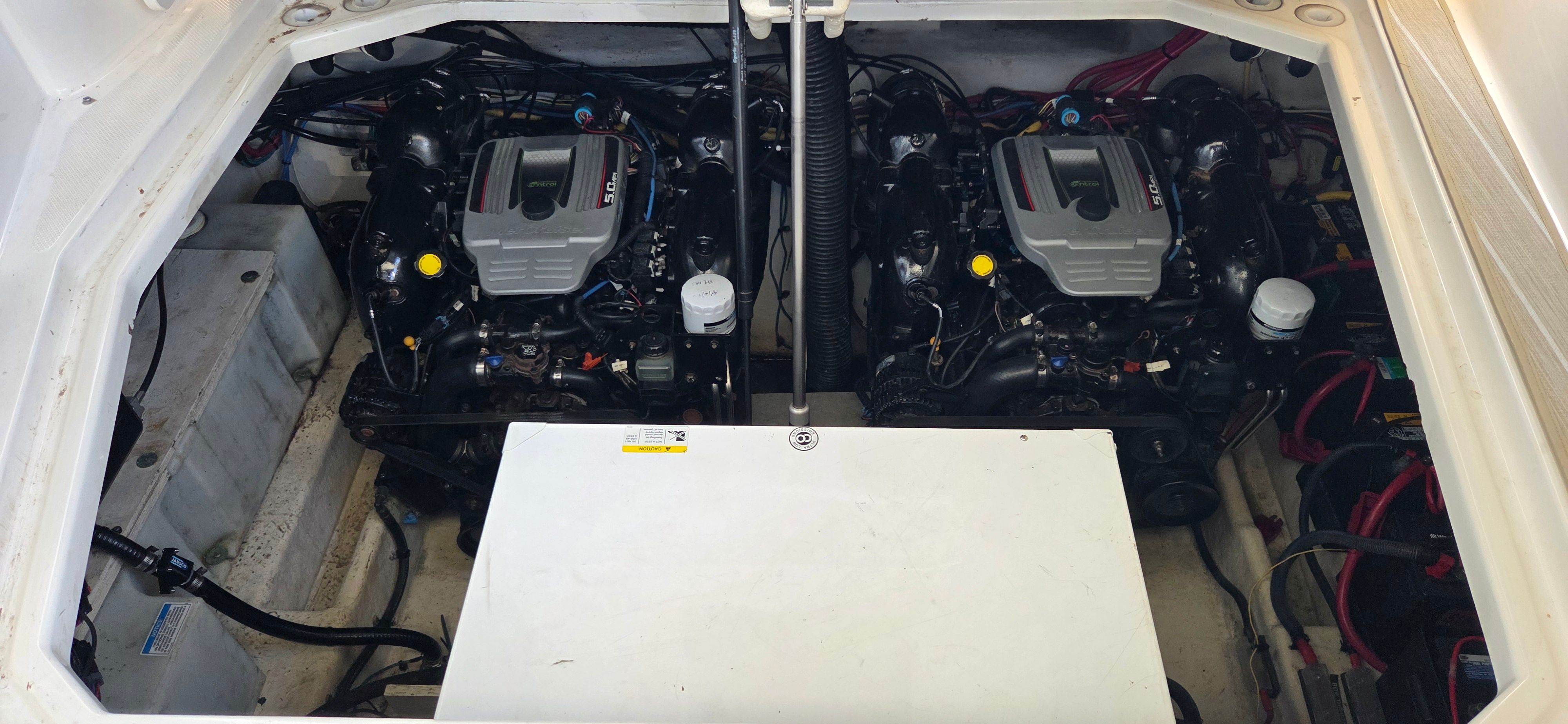 Engine compartment of 2012 Bayliner 335 Cruiser with dual engines.