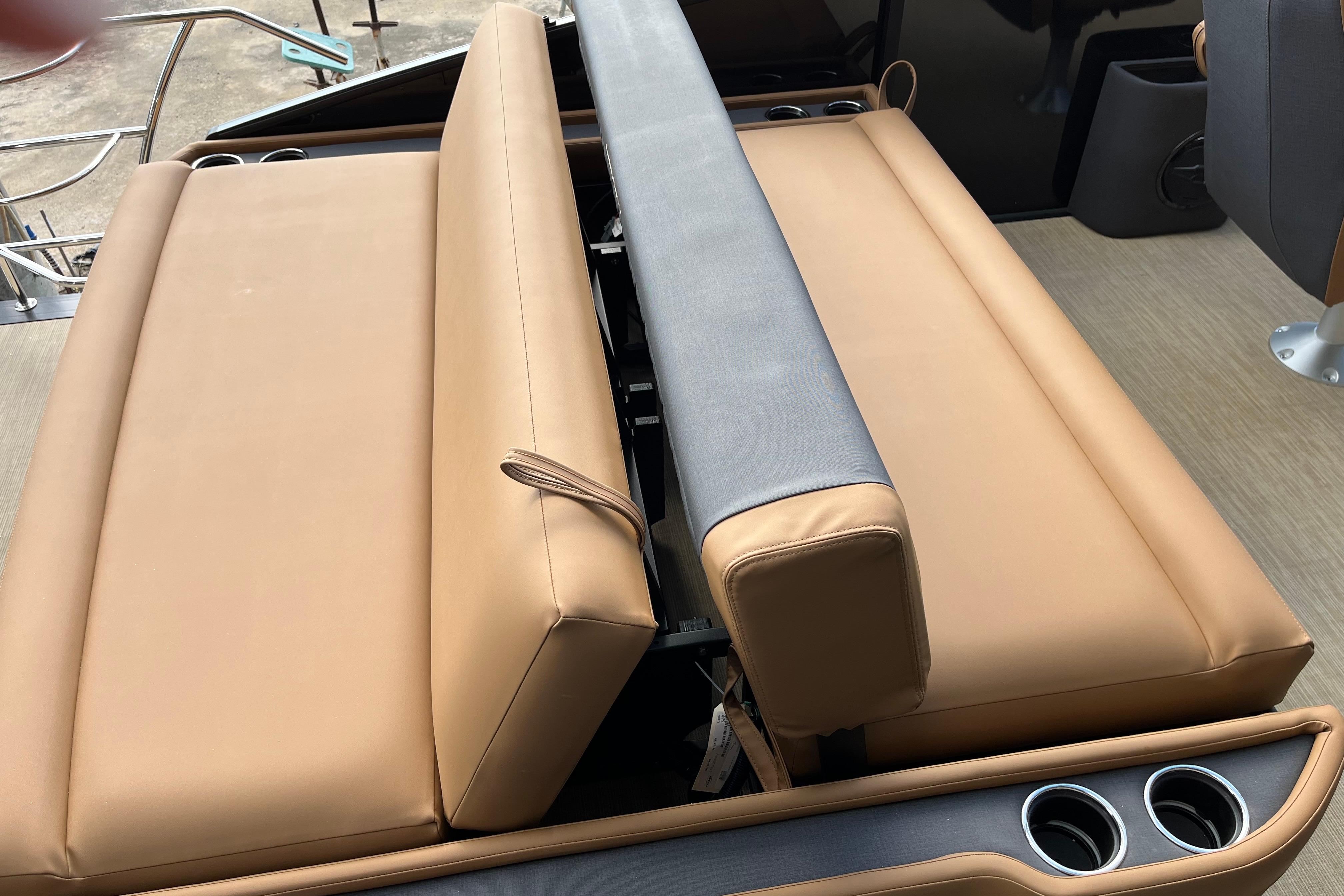 2025 Harris Sunliner 250 boat interior with tan seating and cup holders.
