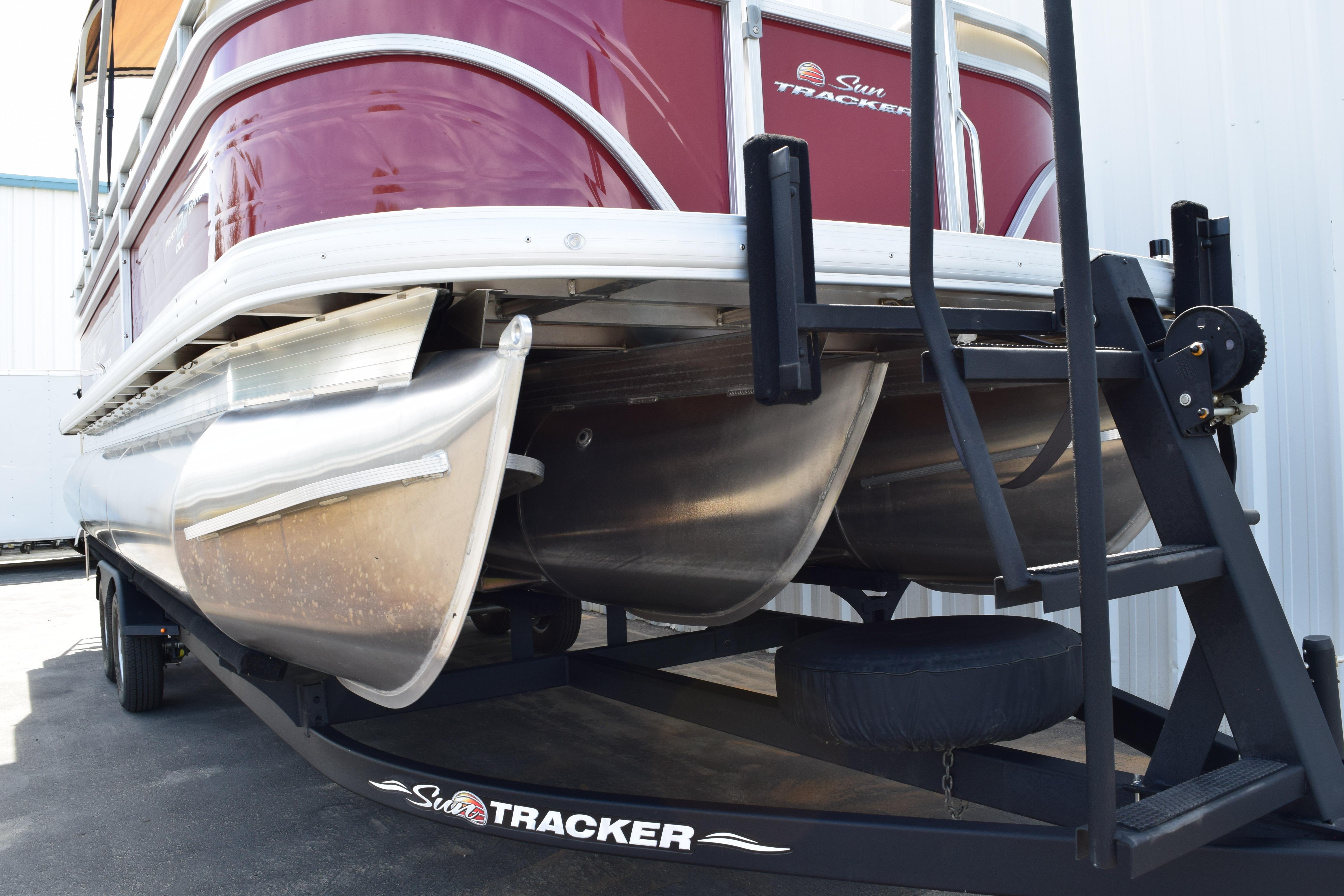 2025 Sun Tracker Party Barge 22 XP3 pontoon boat on trailer, close-up view.