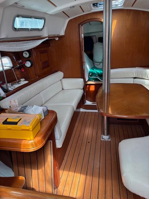 Interior of 2002 Beneteau 361 sailboat with wooden finish and white seating.