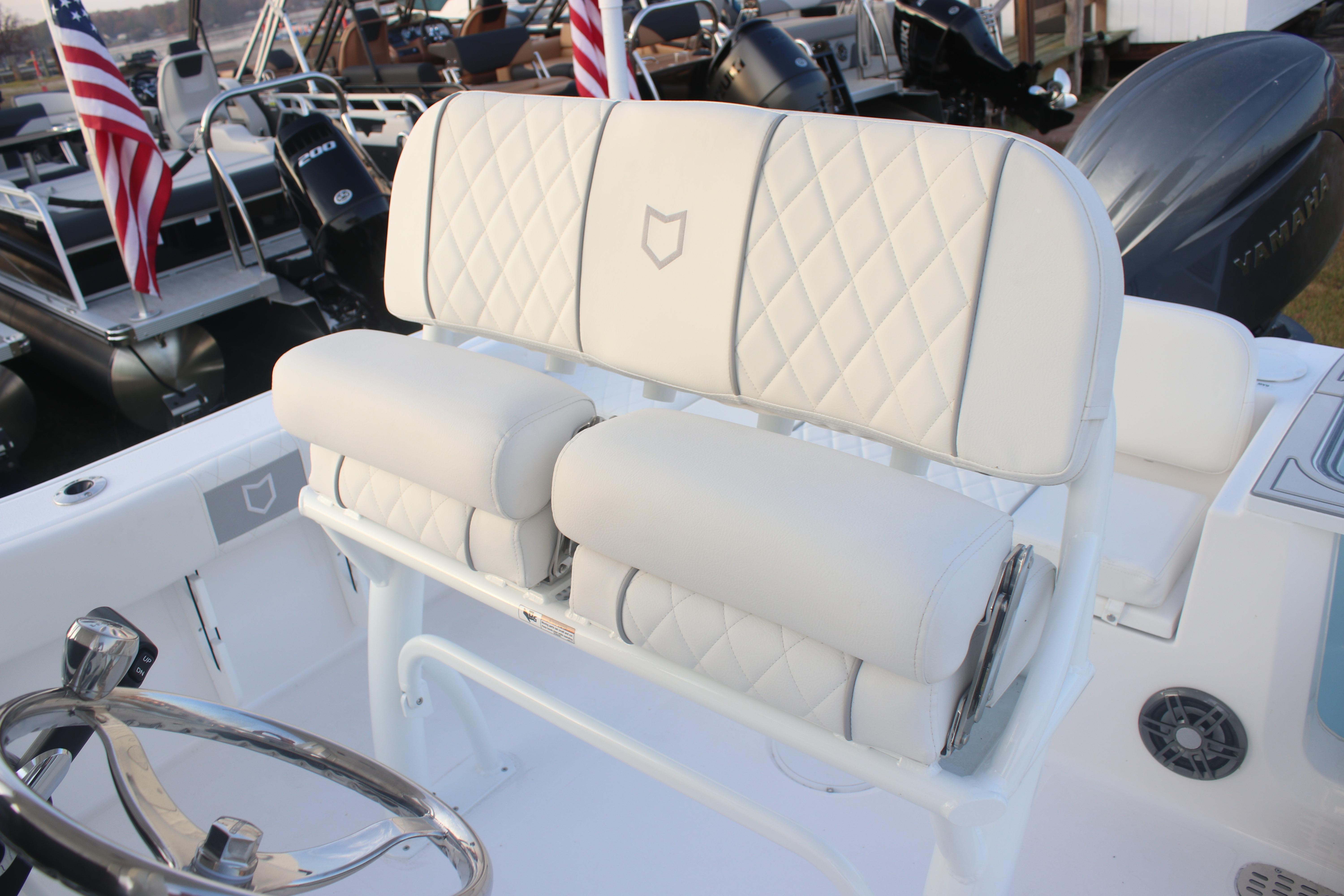 2026 Sea Fox 228 Commander boat with white cushioned seating and steering wheel.