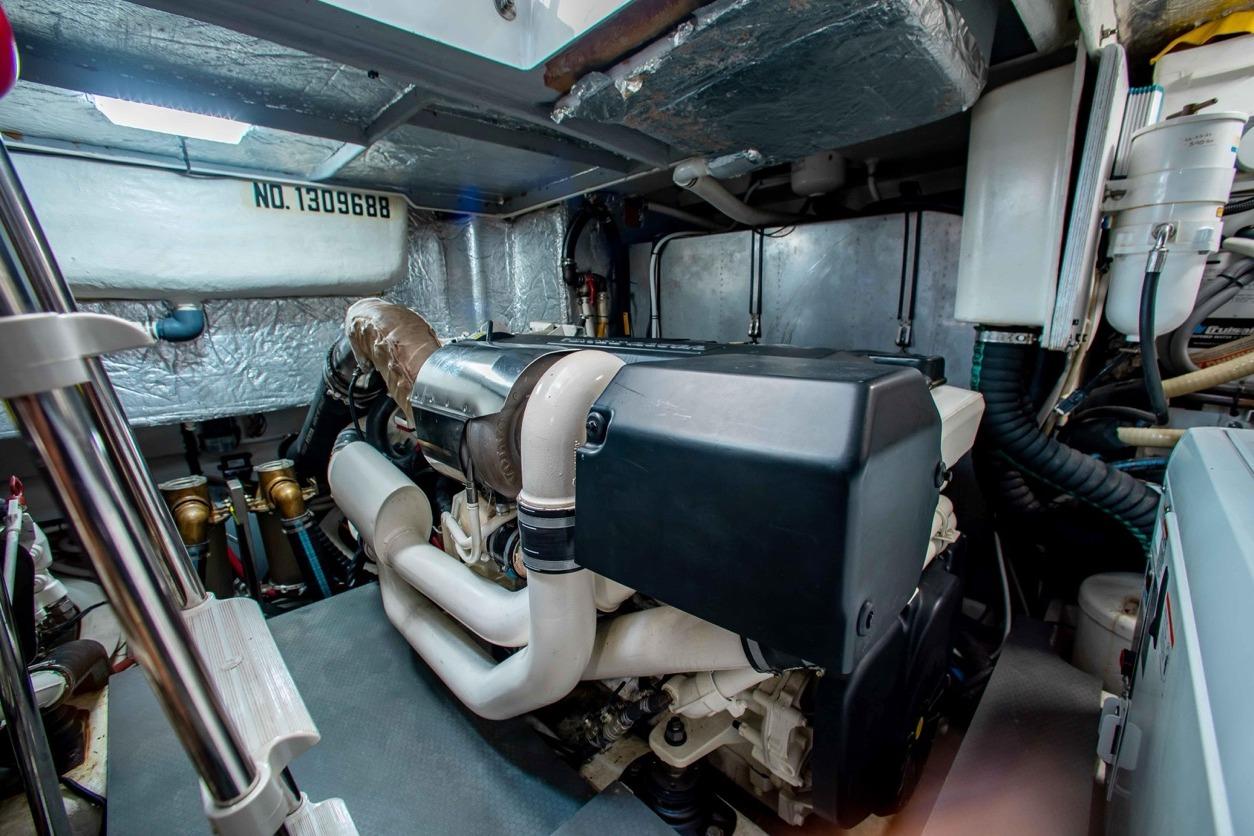 Engine room of a 2015 Absolute 56 FLY yacht, showcasing mechanical components.