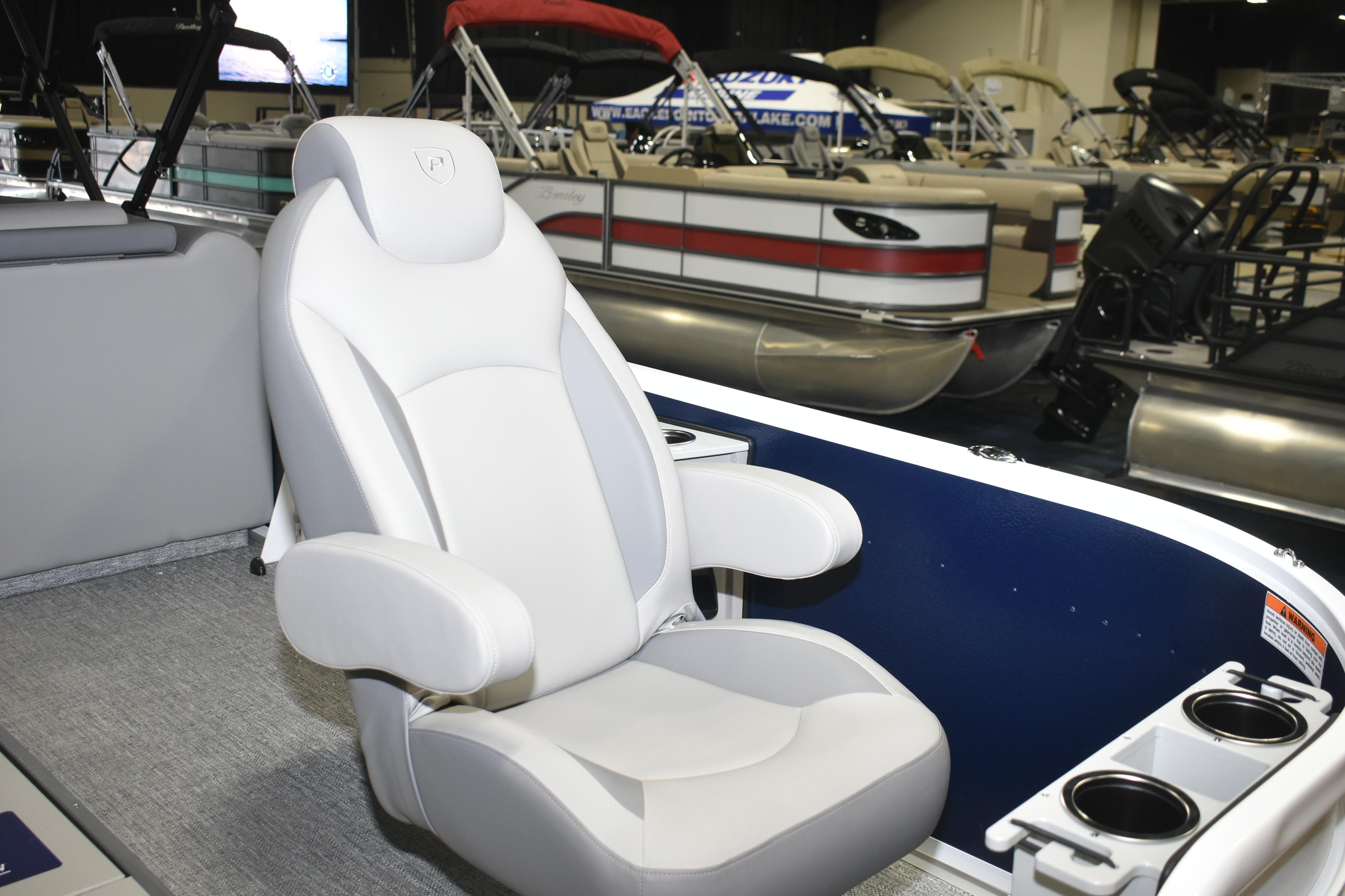 Luxurious seating on 2026 Premier 230 Sunsation Angler 4PT boat at a showroom.