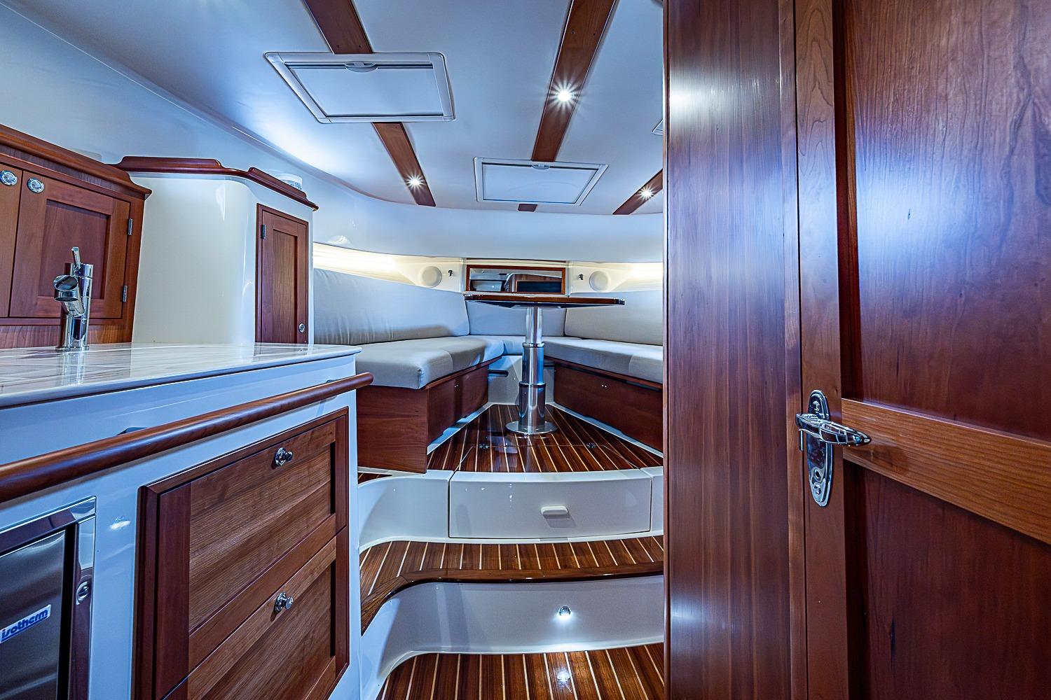 Luxurious interior of 2023 Hinckley Sport Boat 40 X with elegant wood finishes.