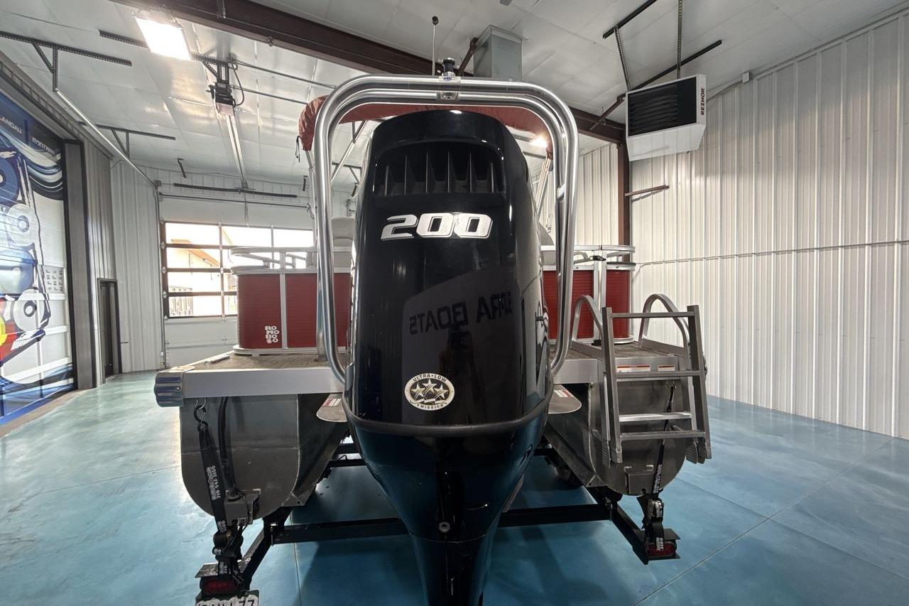 2022 Landau ALURE 232 boat with 200 HP engine in a garage setting.