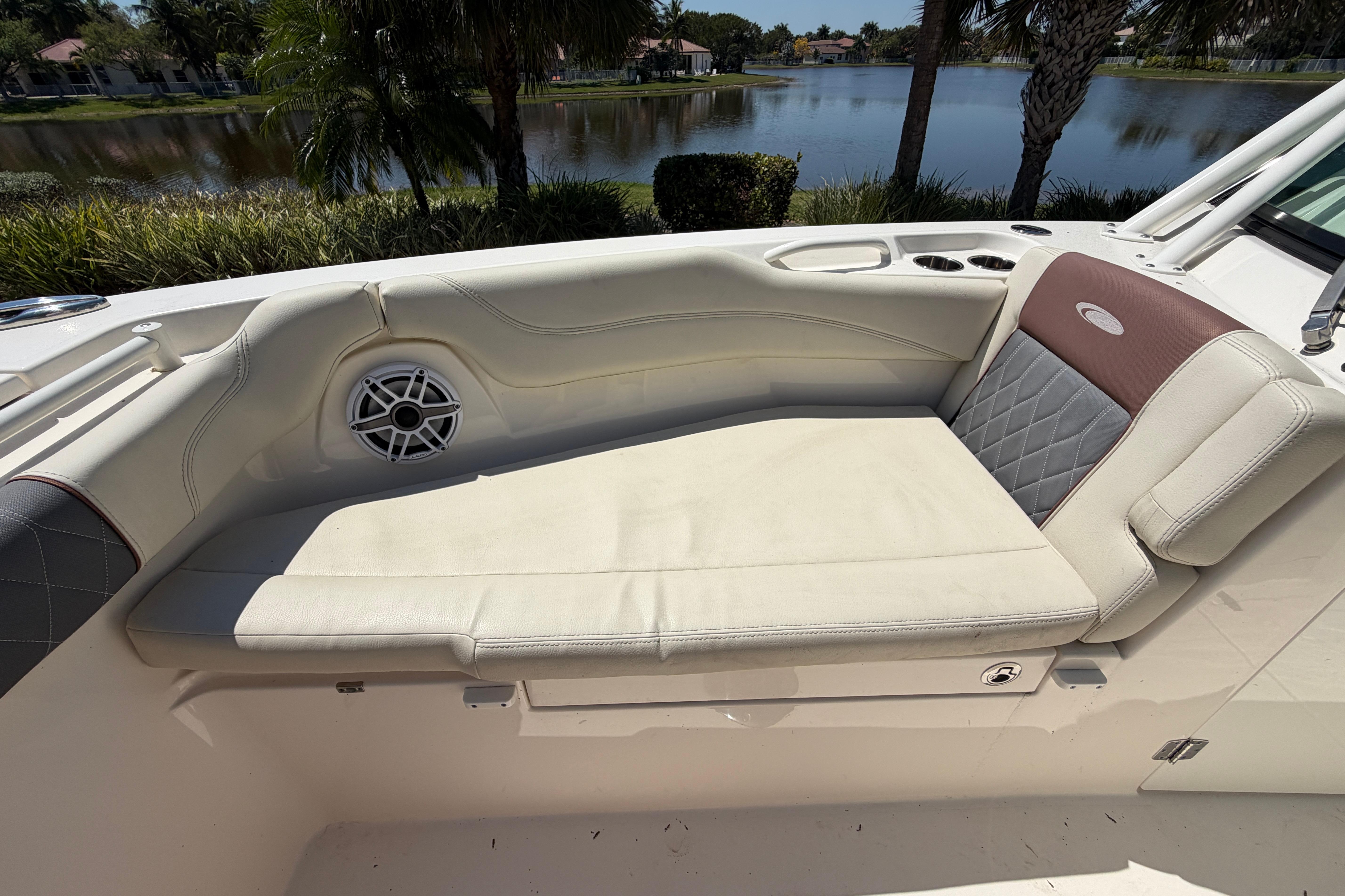2021 Cobia 280 Dual Console boat interior with cushioned seating and speaker.