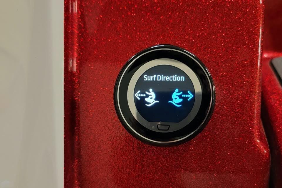 2023 Supra SE 550 surf direction control on a sparkling red dashboard.