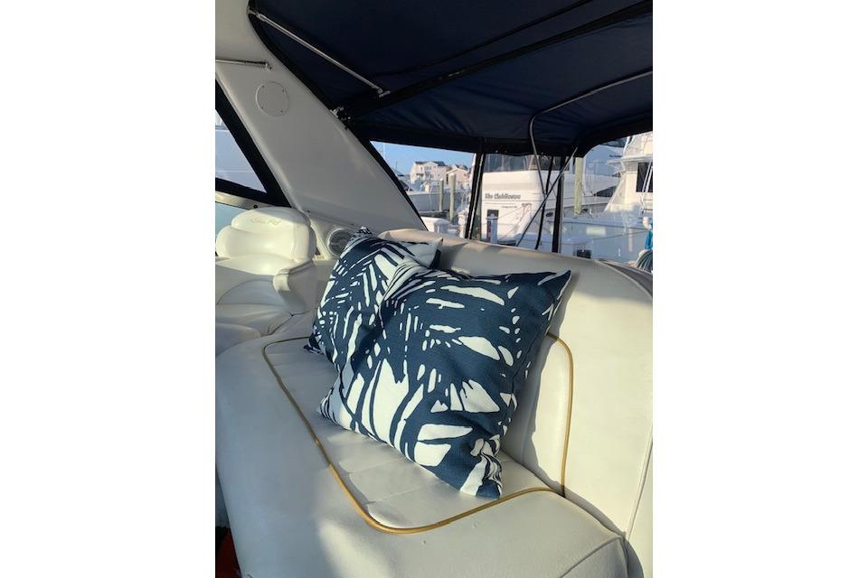 Luxurious interior of 1999 Sea Ray Sundancer 400 yacht with stylish cushions.