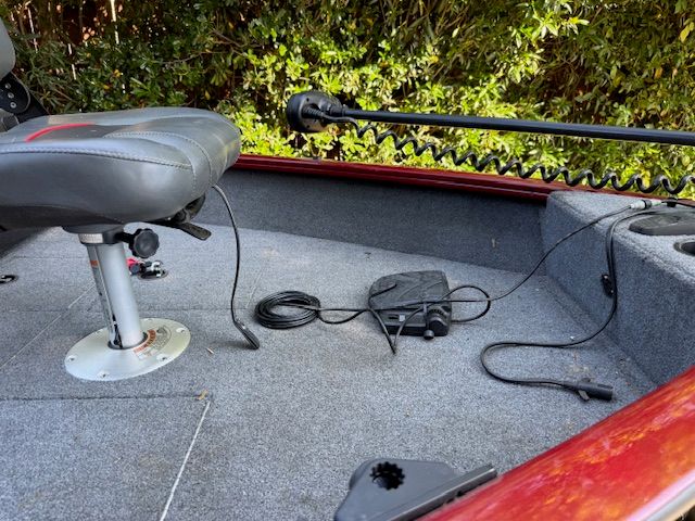 The image shows the cockpit of a Tracker PGV16WT 16 boat with a gray seat and controls.