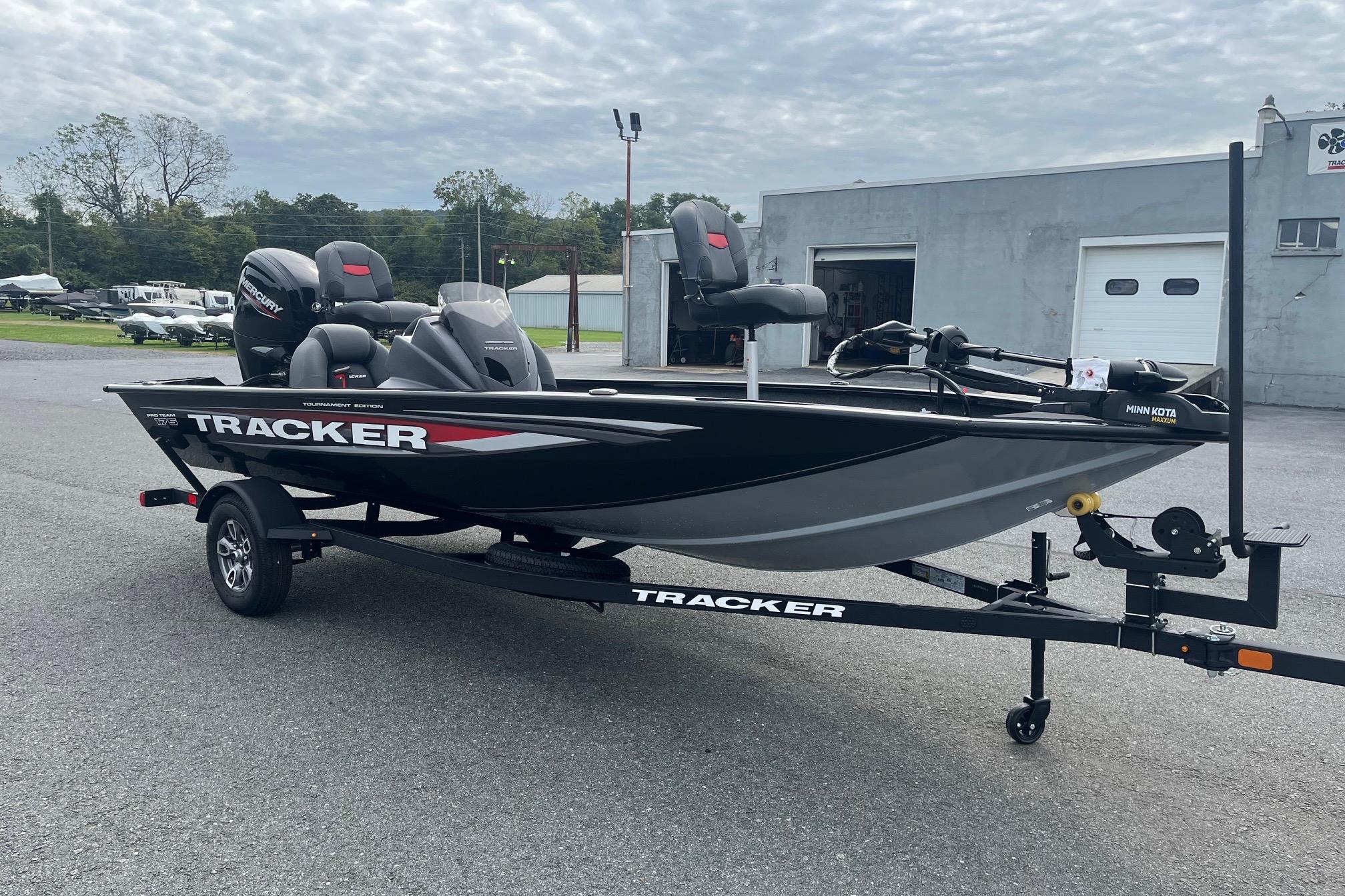 2026 Tracker Pro Team 175 boat on trailer, parked outdoors, with overcast sky.