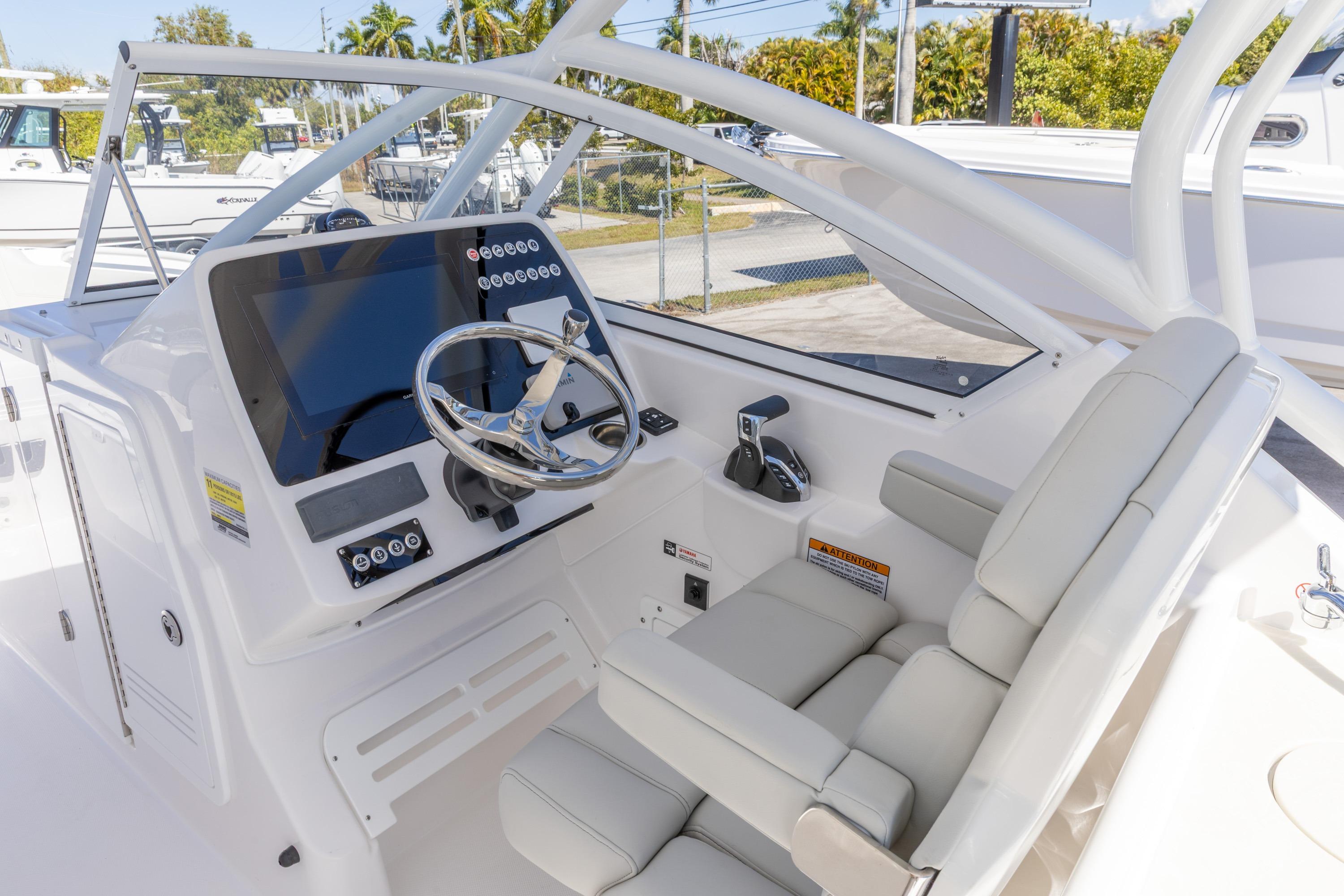 2026 Edgewater 248CX Crossover boat cockpit with modern steering and controls.