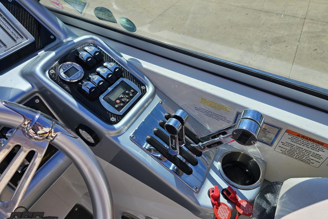 Control panel of a 2014 Formula 292 FASTech boat with steering wheel and throttle levers.