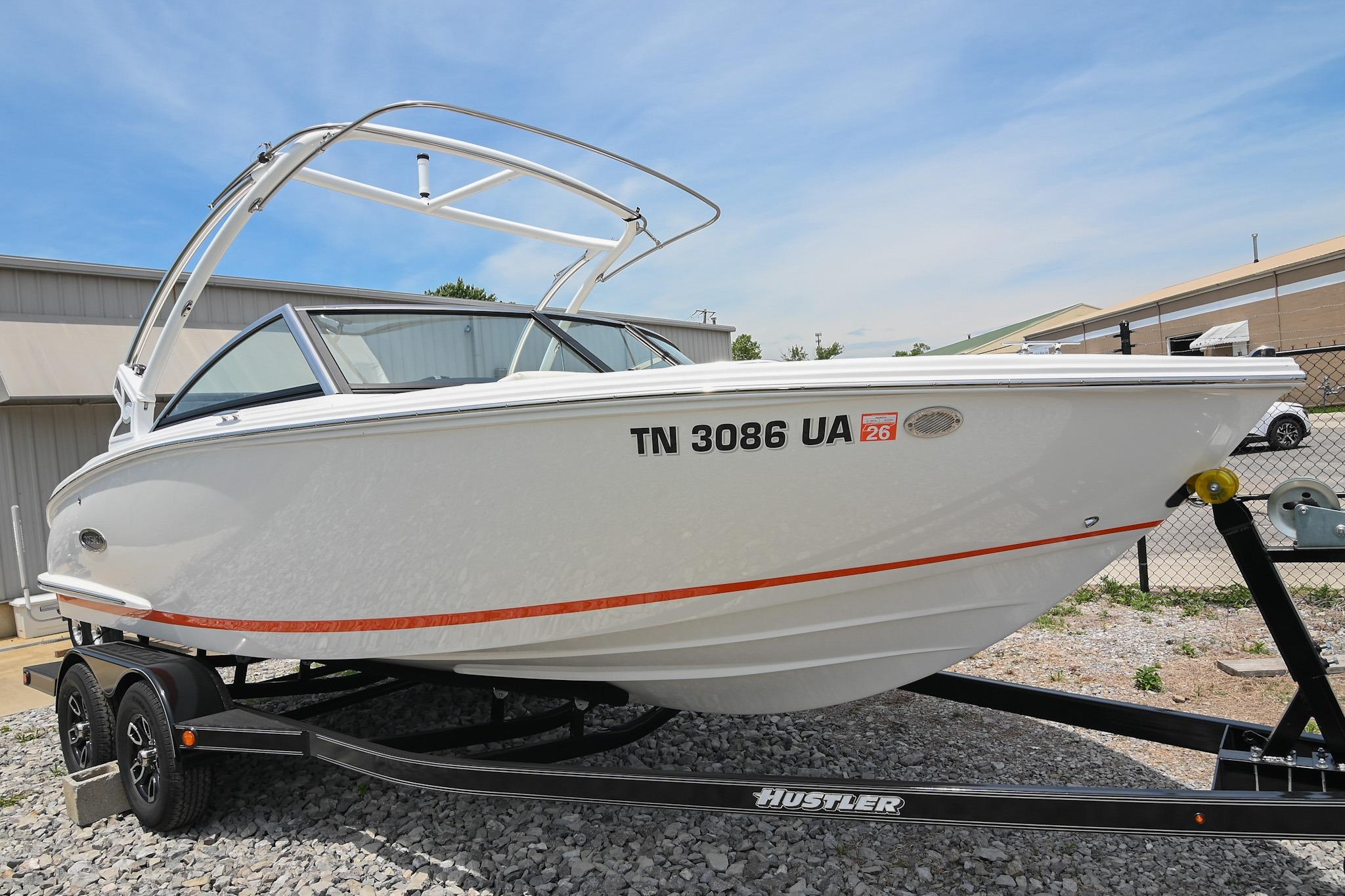 2022 Cobalt CS22 boat on trailer, white exterior, parked outdoors on gravel.
