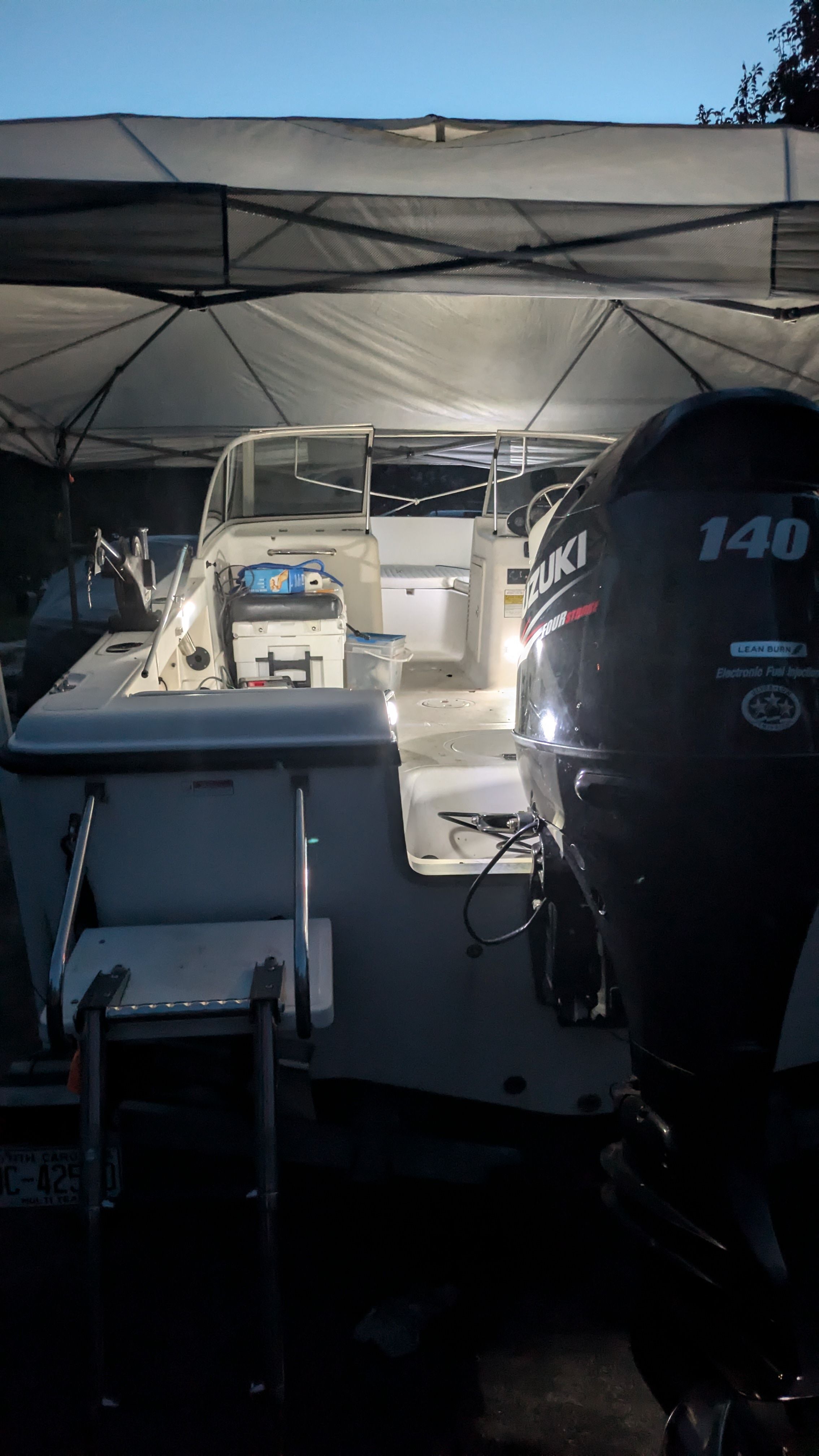 Sea Hunt Escape 200 boat with Suzuki engine under canopy.