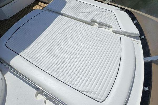 Sunseeker Manhattan 66 (2005) yacht sunpad with white cushioned seating.