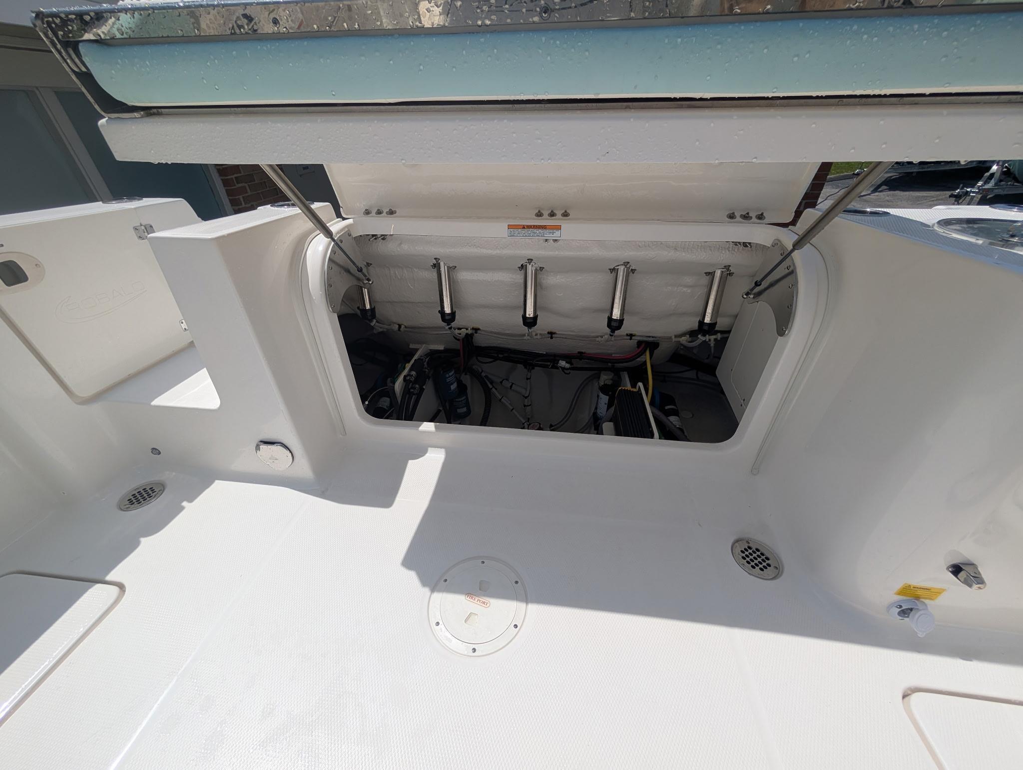 2025 Robalo R250 Center Console boat with open storage compartment.