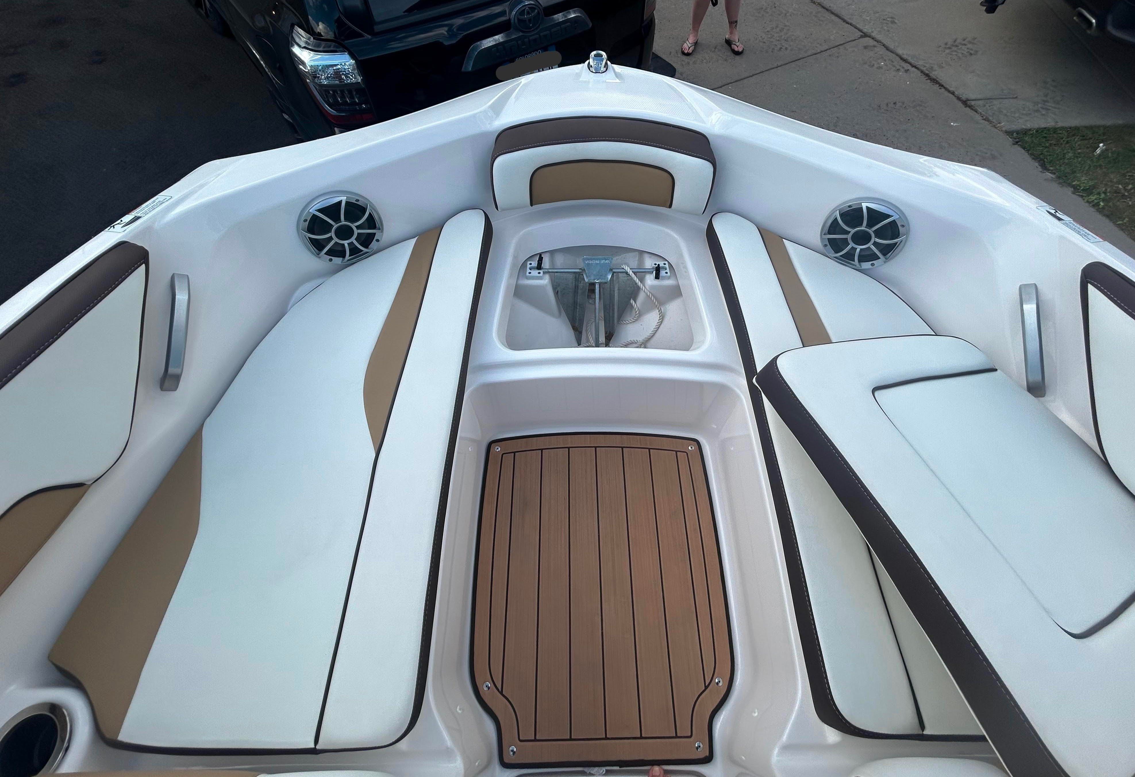 Interior of a 2022 Yamaha Boats 195S with white and brown seating.