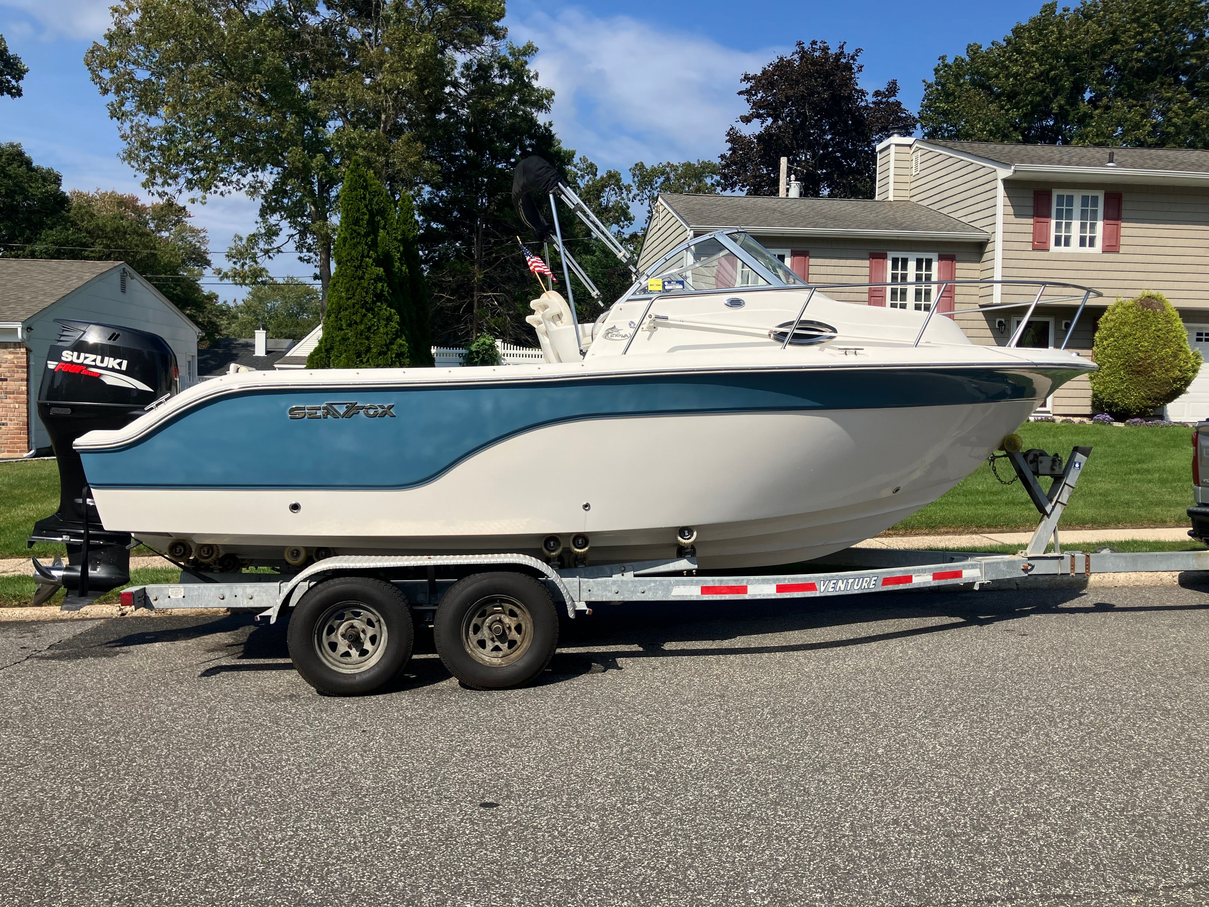 Custom 216wa pro boat on trailer in front of house, year 2010.