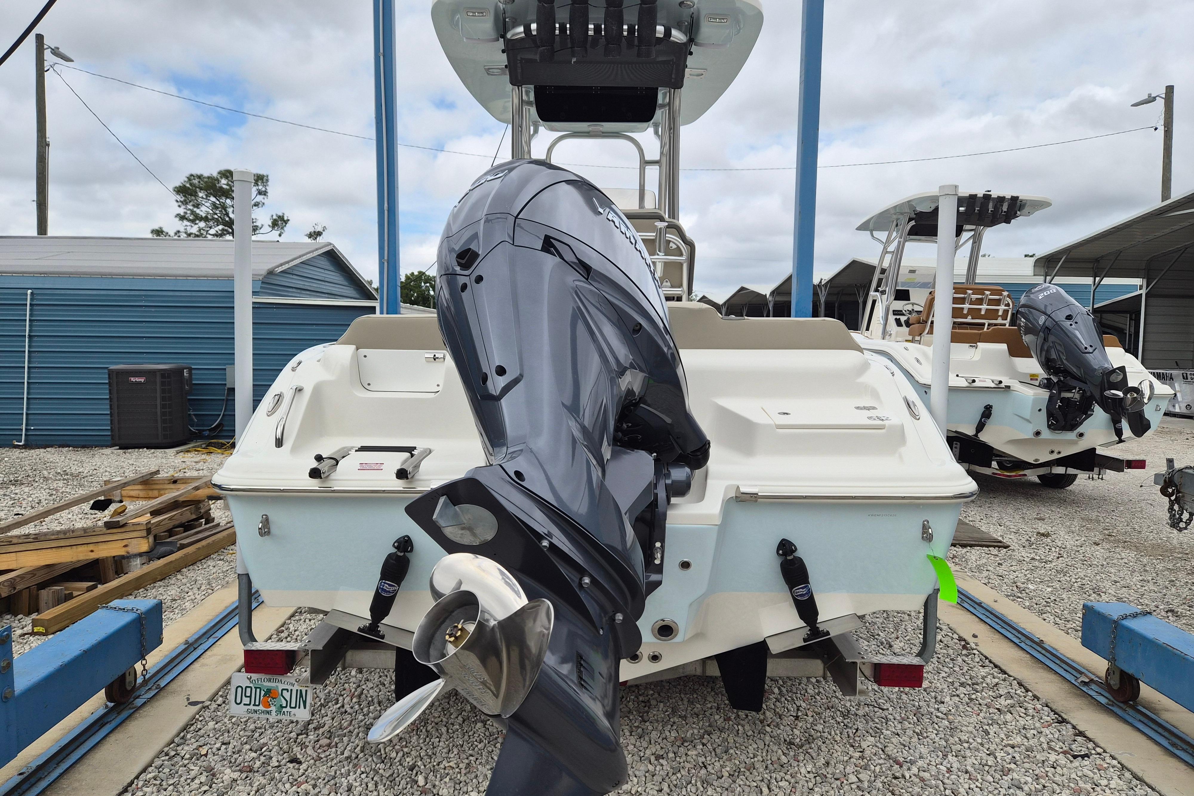 2026 Key West 219 FS boat with outboard motor in a marina setting.