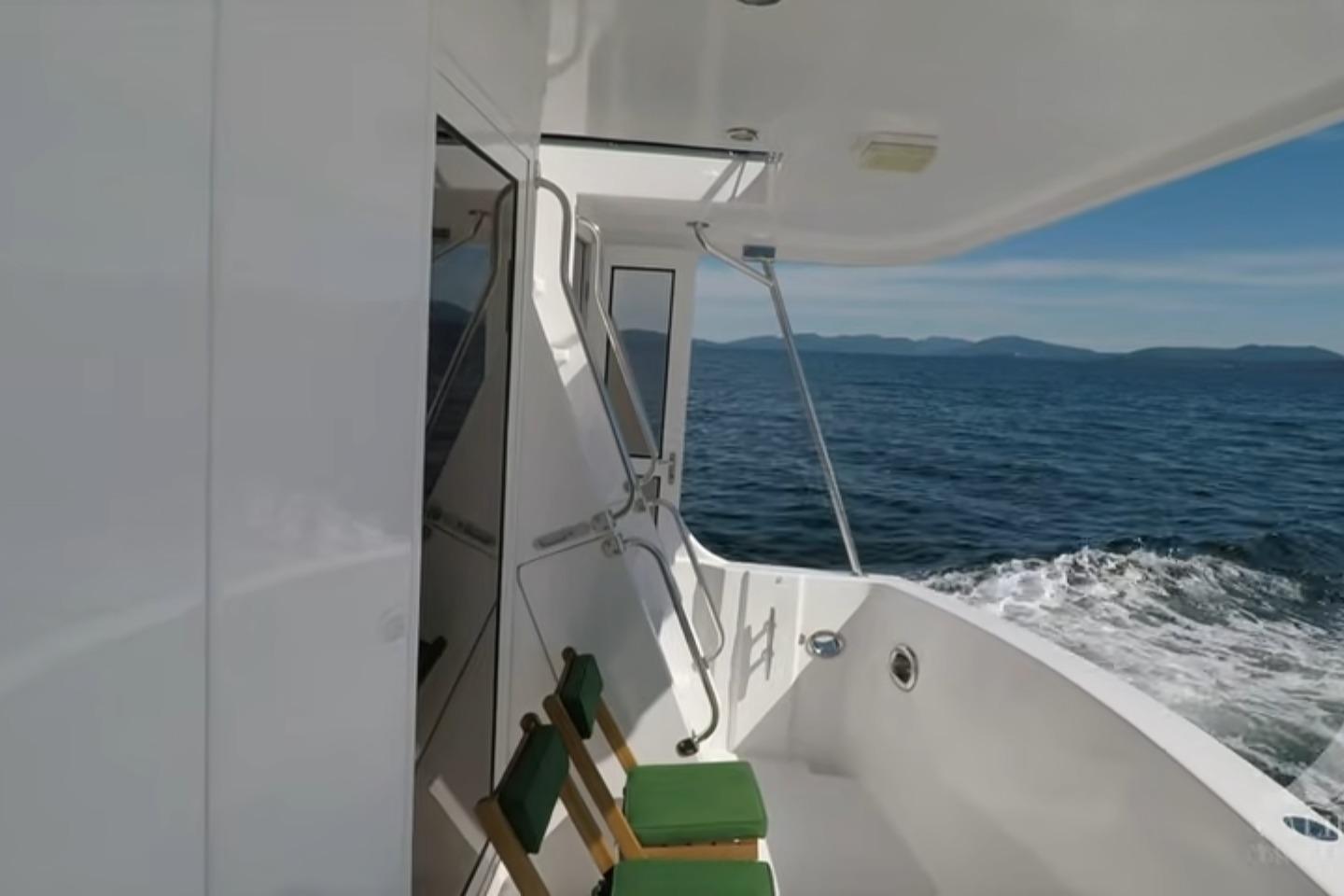 2003 Jefferson Pilothouse 53 yacht cruising on open water with scenic ocean view.