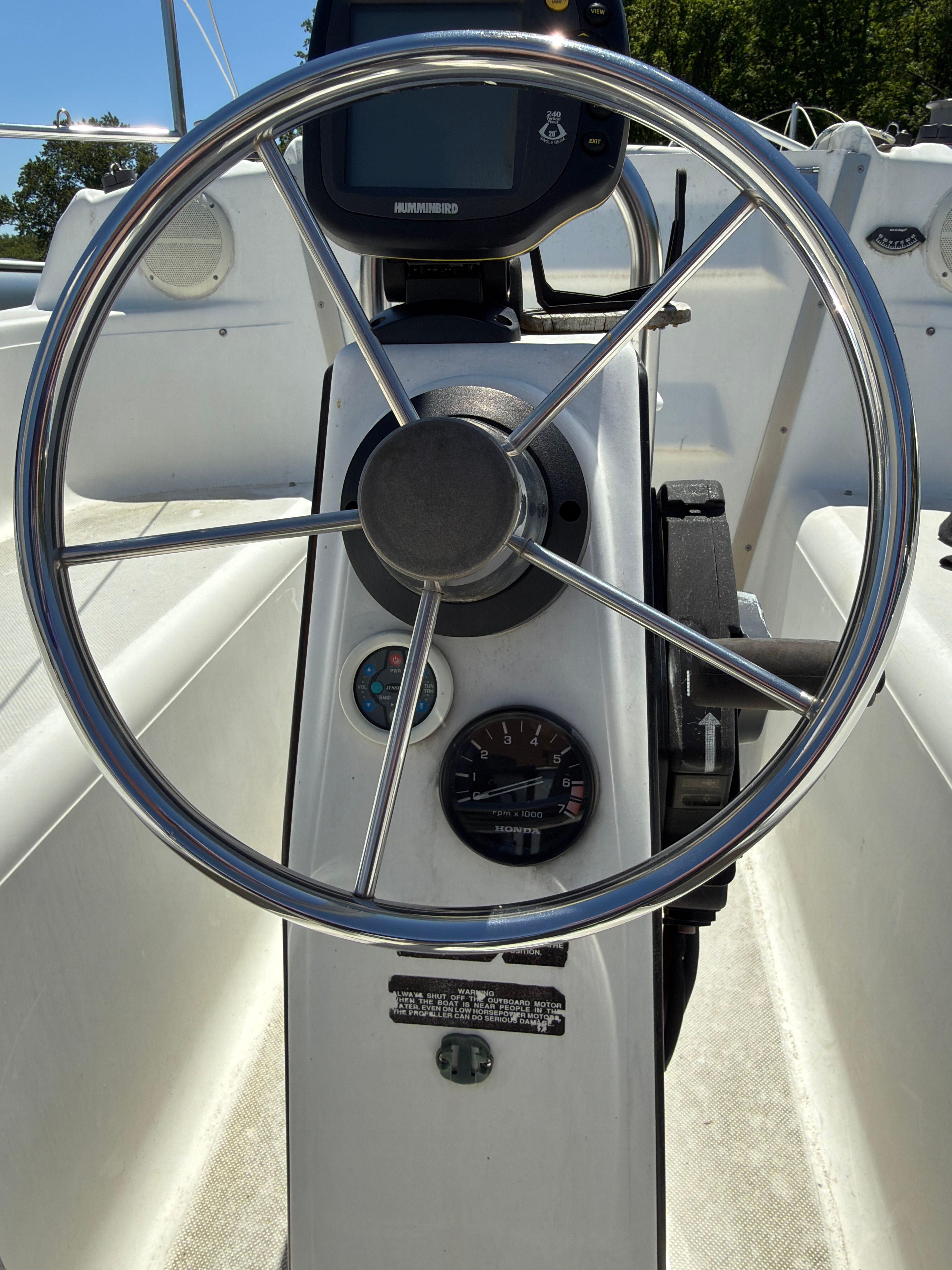 Steering wheel of a 2006 MacGregor 26X yacht with instruments.
