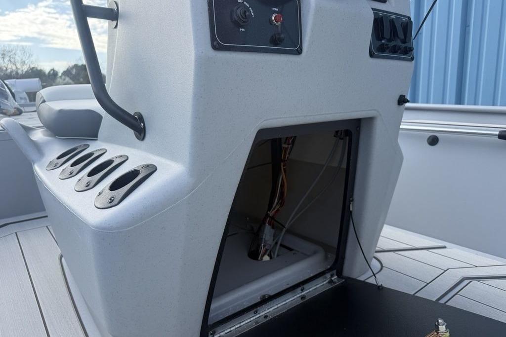 2026 Tracker Bass Tracker Classic CC boat console with open storage compartment and rod holders.