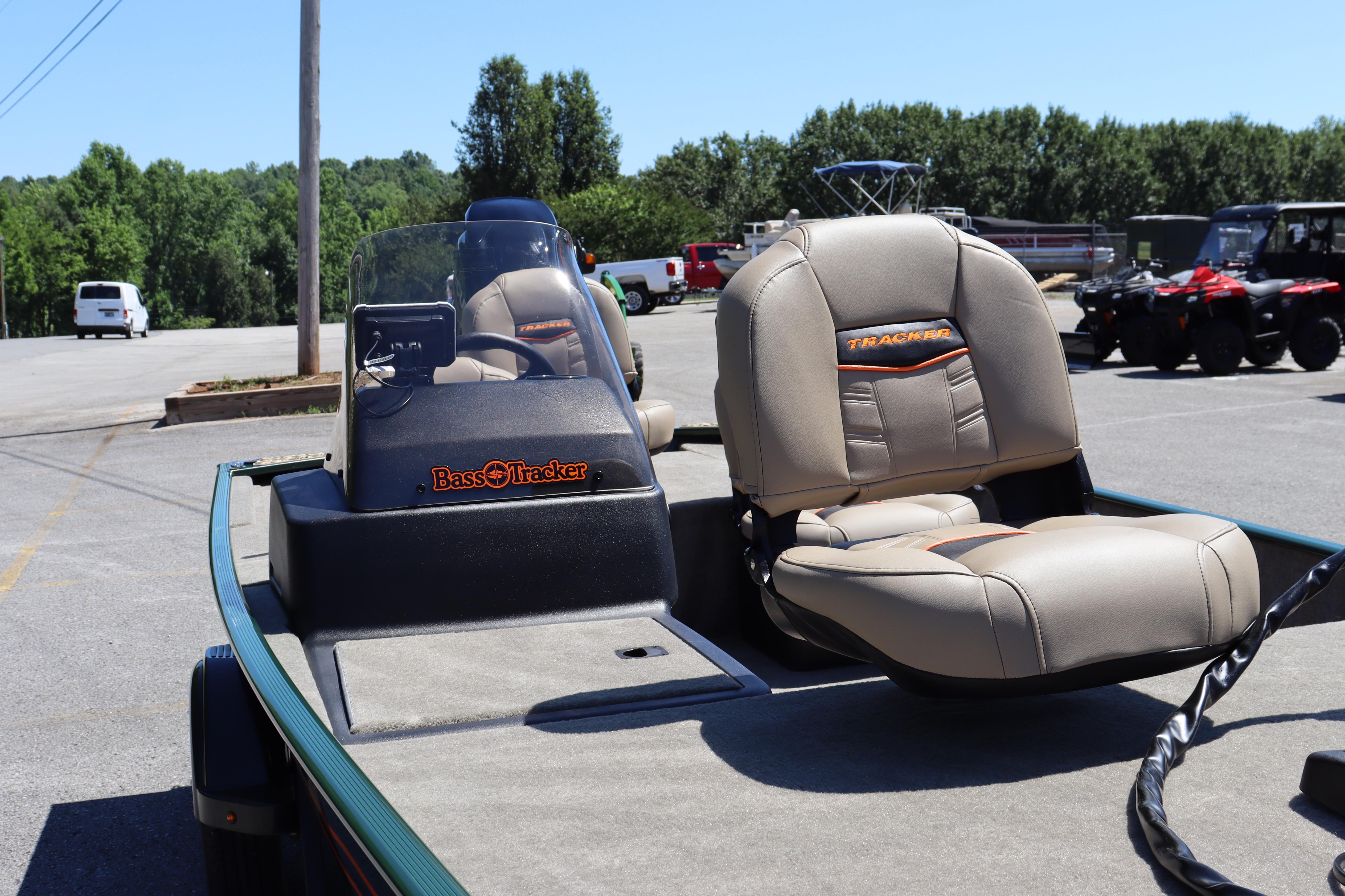 2026 Tracker Bass Tracker Classic Limited boat with beige seats in a parking lot.