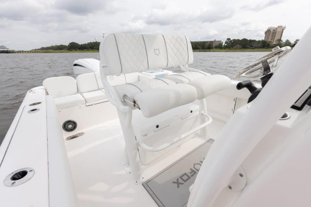 2027 Sea Fox 248 Commander boat interior with white seating and steering wheel.