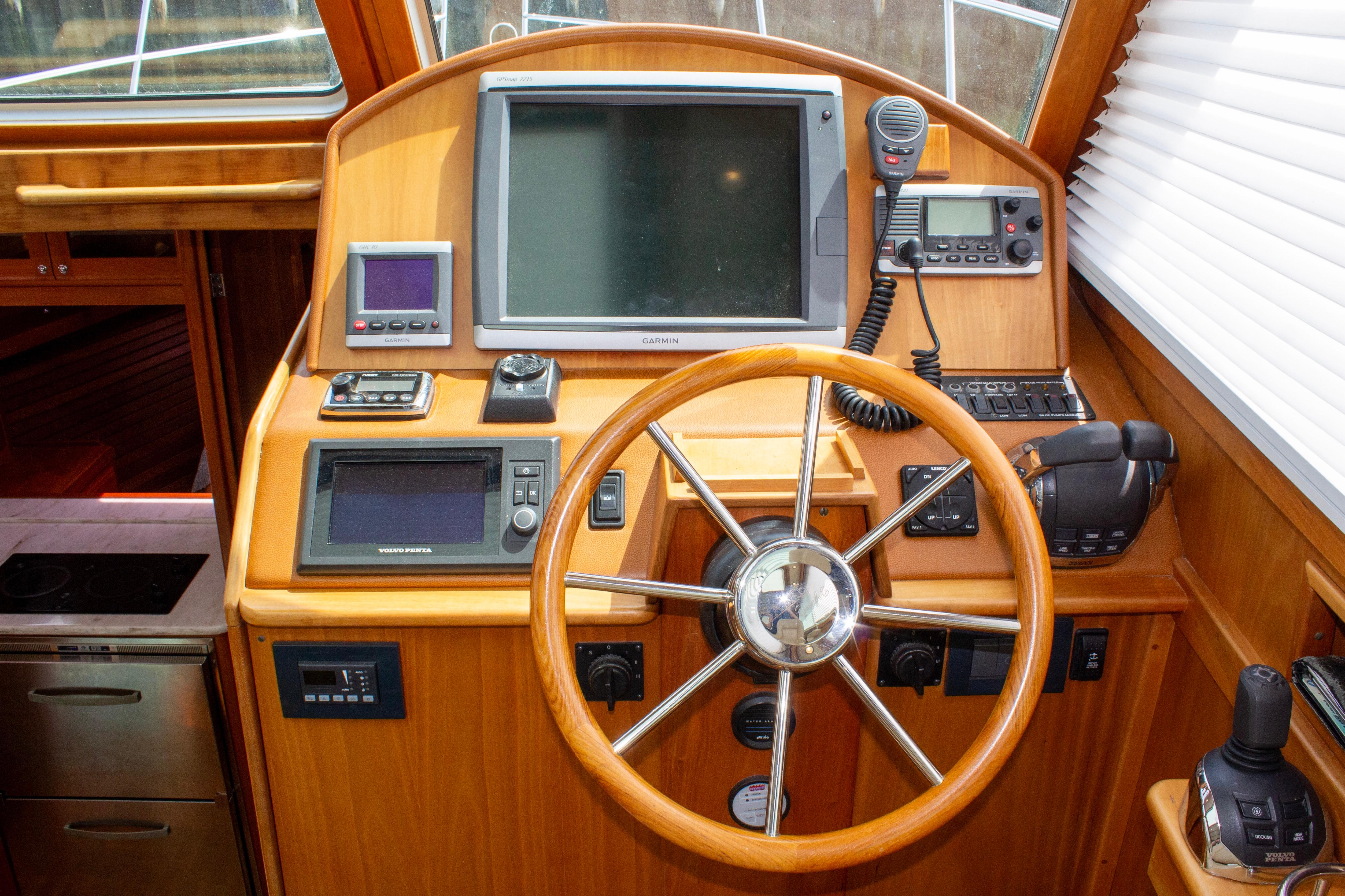 Helm of 2013 Sabre 38 Salon Express with navigation equipment and wooden steering wheel.