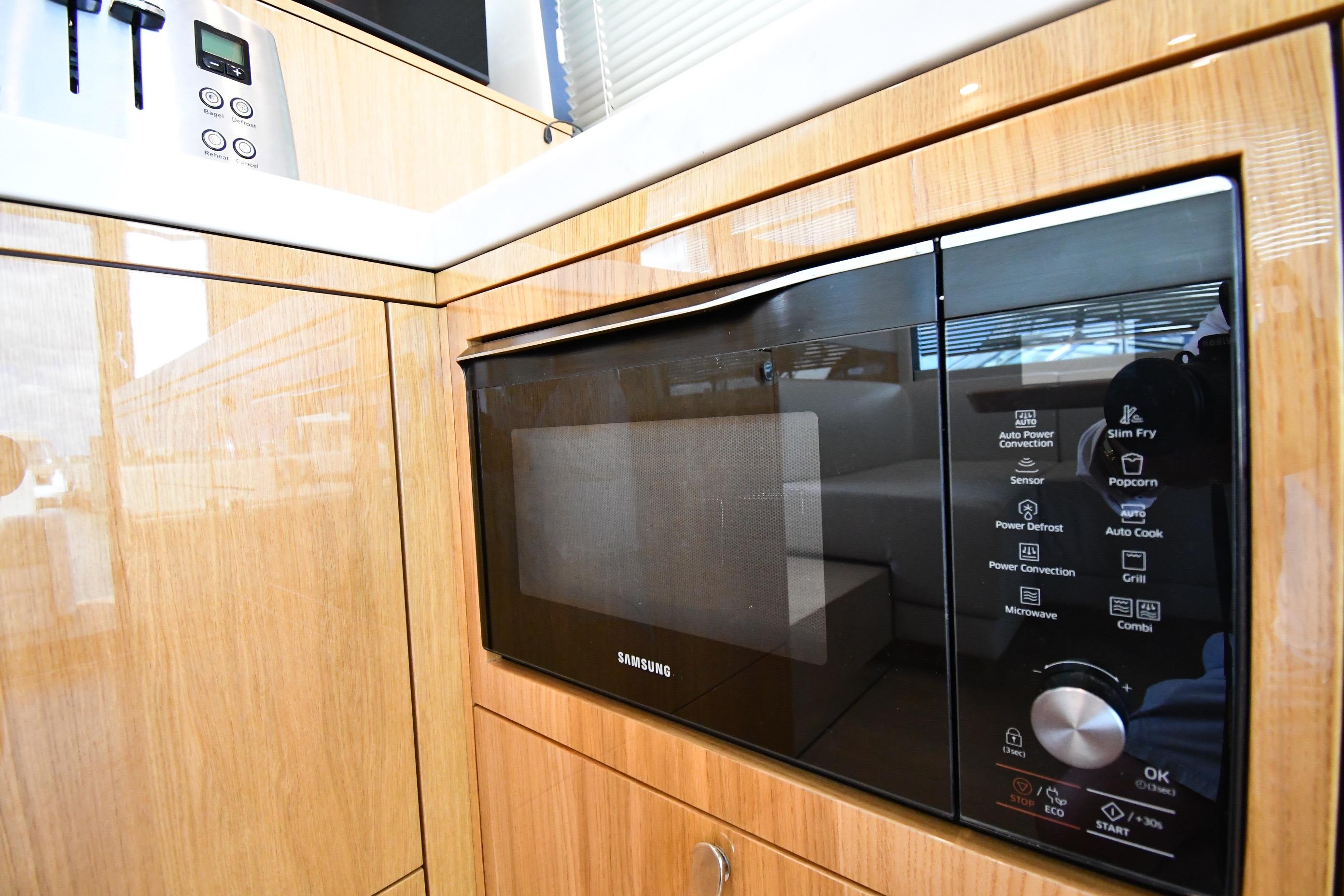 Modern kitchen in 2024 Fairline G50 Targa yacht with Samsung microwave.