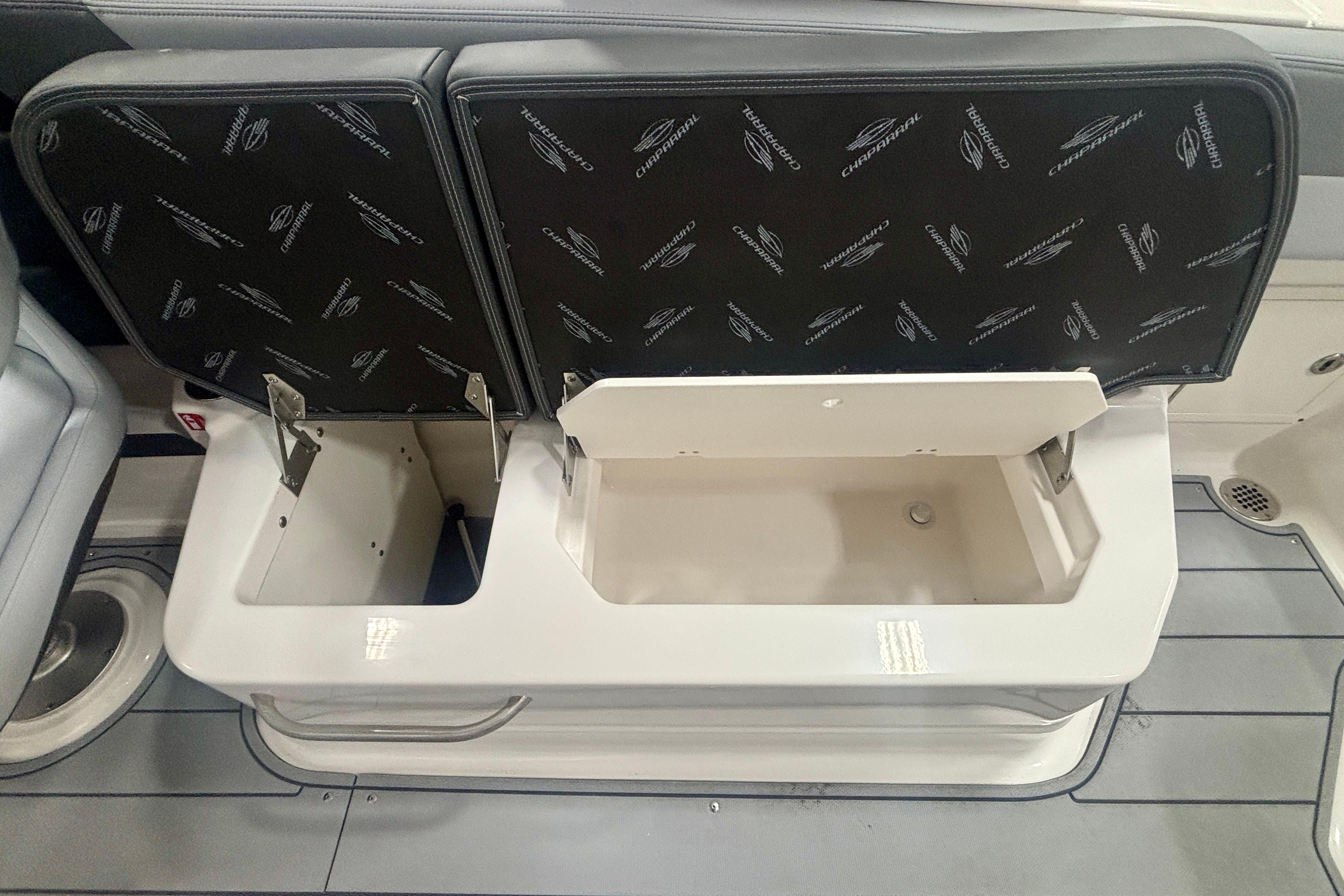2026 Chaparral SSX 30 boat storage compartments with open seats, showcasing interior design.