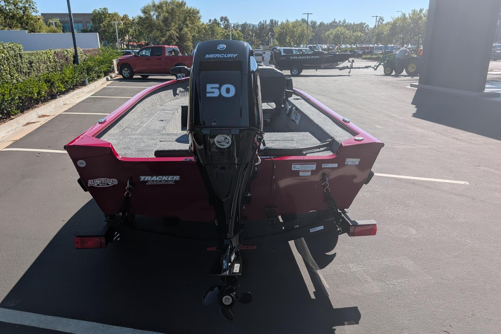 2026 Tracker Super Guide V-16 SC boat with Mercury 50 engine in parking lot.