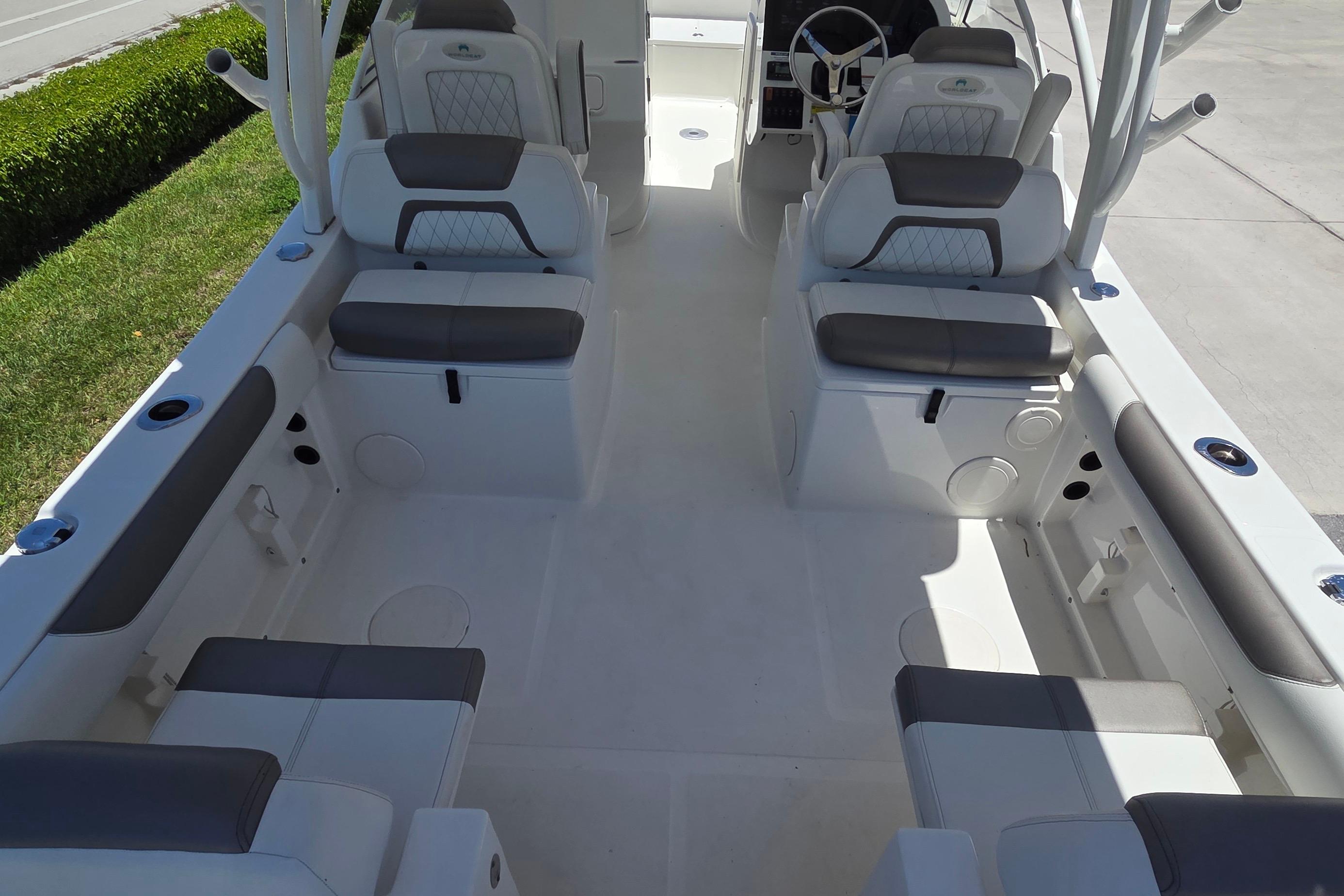 2022 World Cat 255 DC boat interior with cushioned seating and steering console.