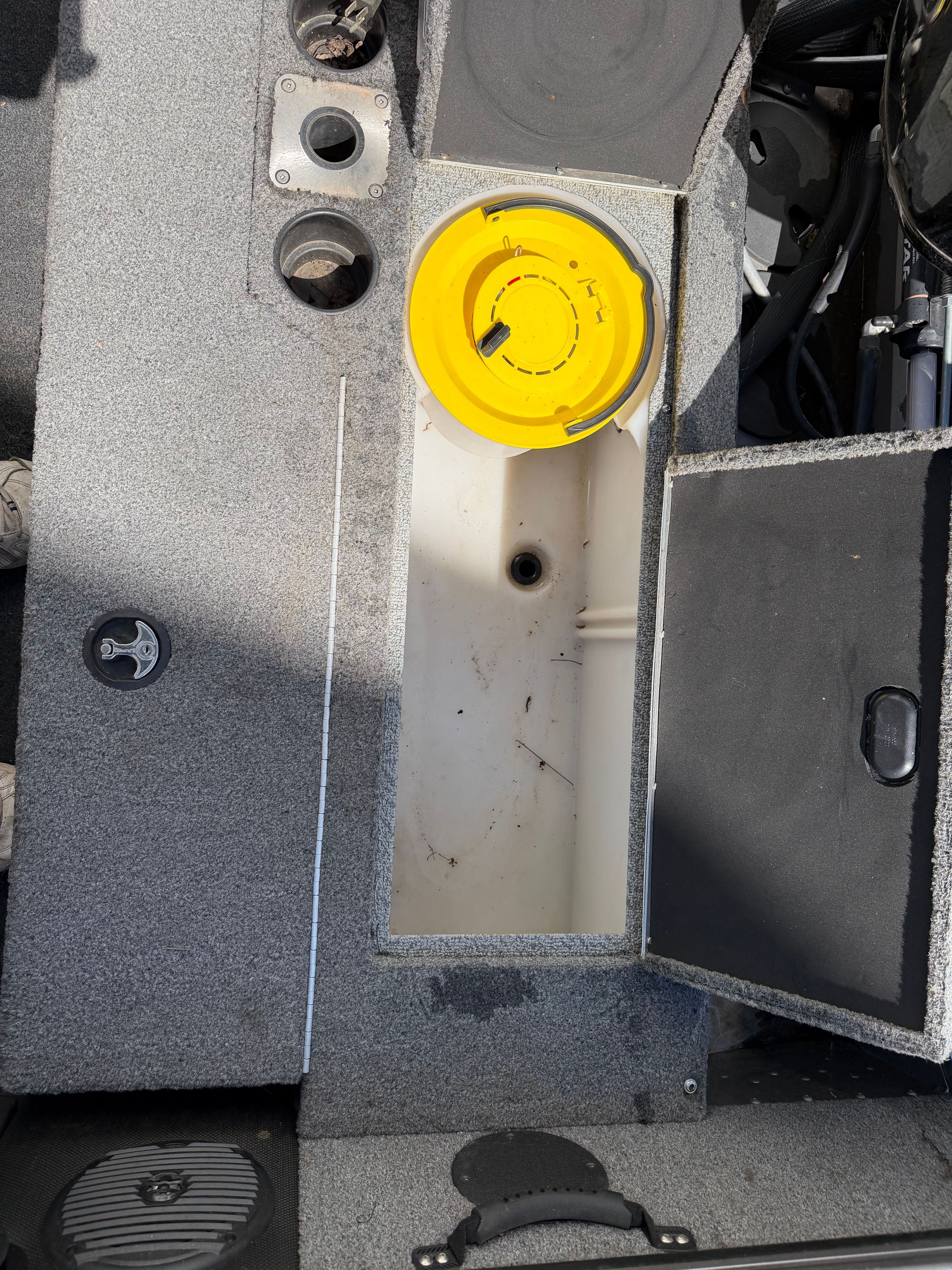 Interior view of a 2017 Lund Pro V 1975 boat with storage compartment.