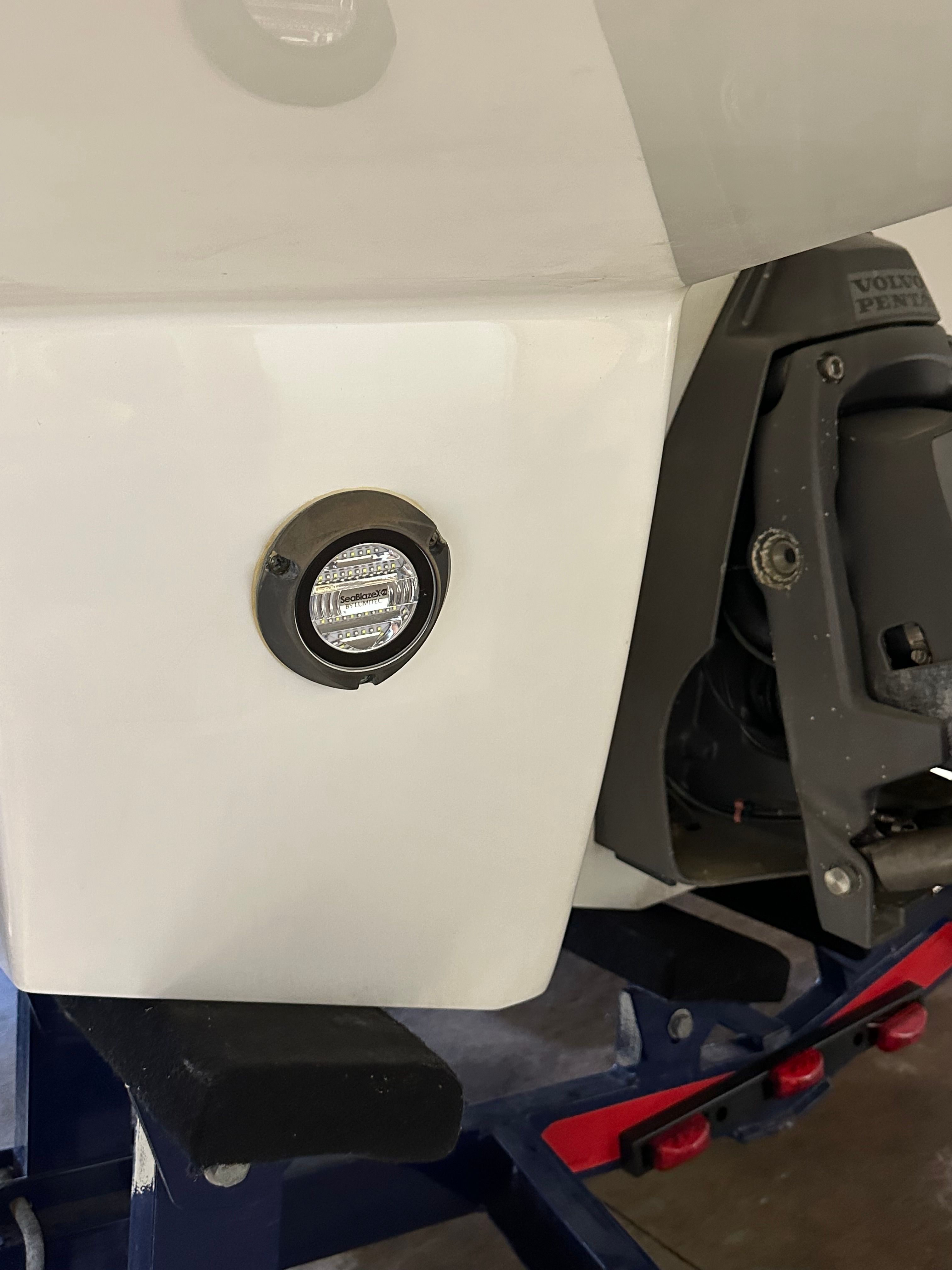 Close-up of a boat part featuring a light and an engine.