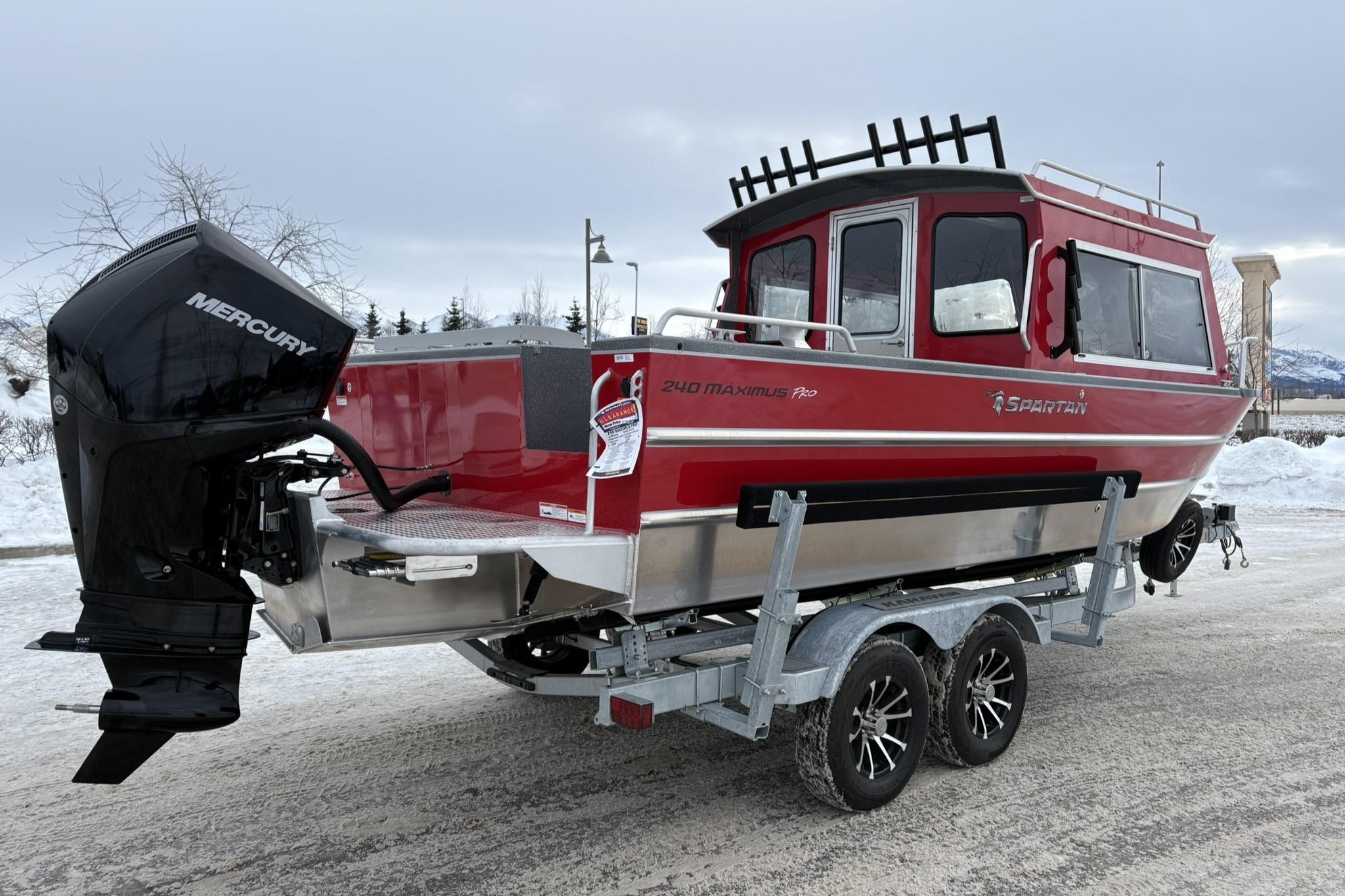 2024 Spartan 240 Maximus Pro boat on trailer, red exterior, Mercury engine, snowy background.