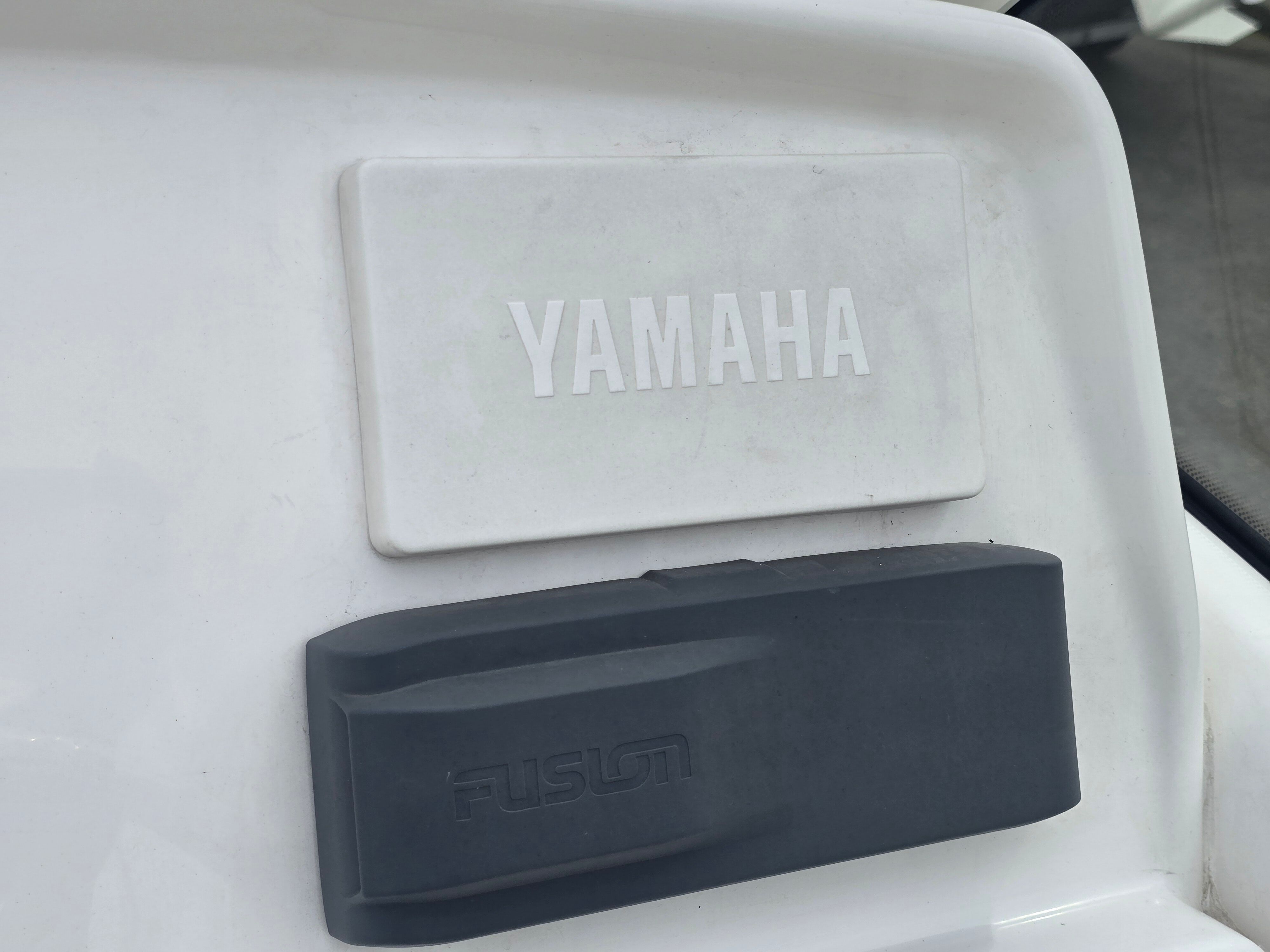 Close-up of a boat engine with Yamaha and Fusion logos.