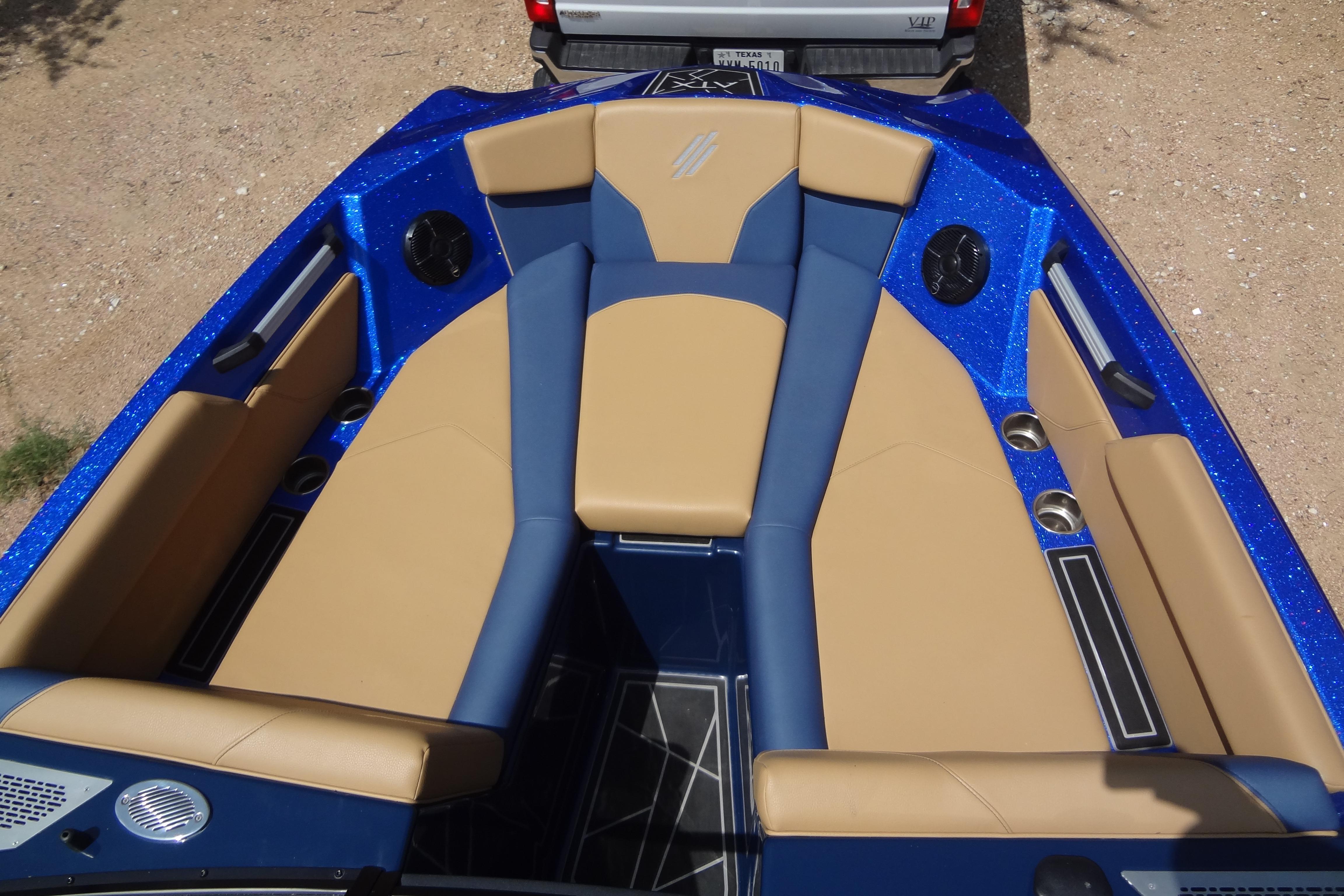 2022 ATX Surf Boats 24 Type-S interior with blue and tan seating, cup holders, and speakers.