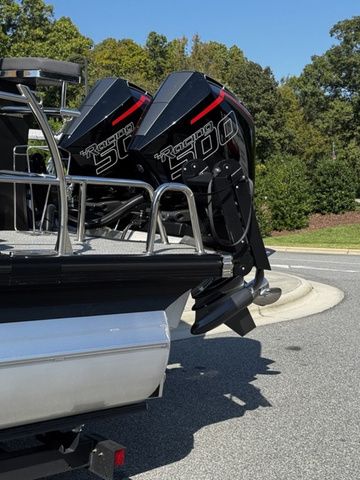 2025 Barletta Lusso L25MAT boat with twin outboard motors, parked on a sunny day.