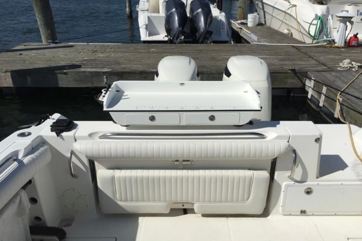 2004 Wellcraft 290 Coastal boat with dual engines docked at a marina.