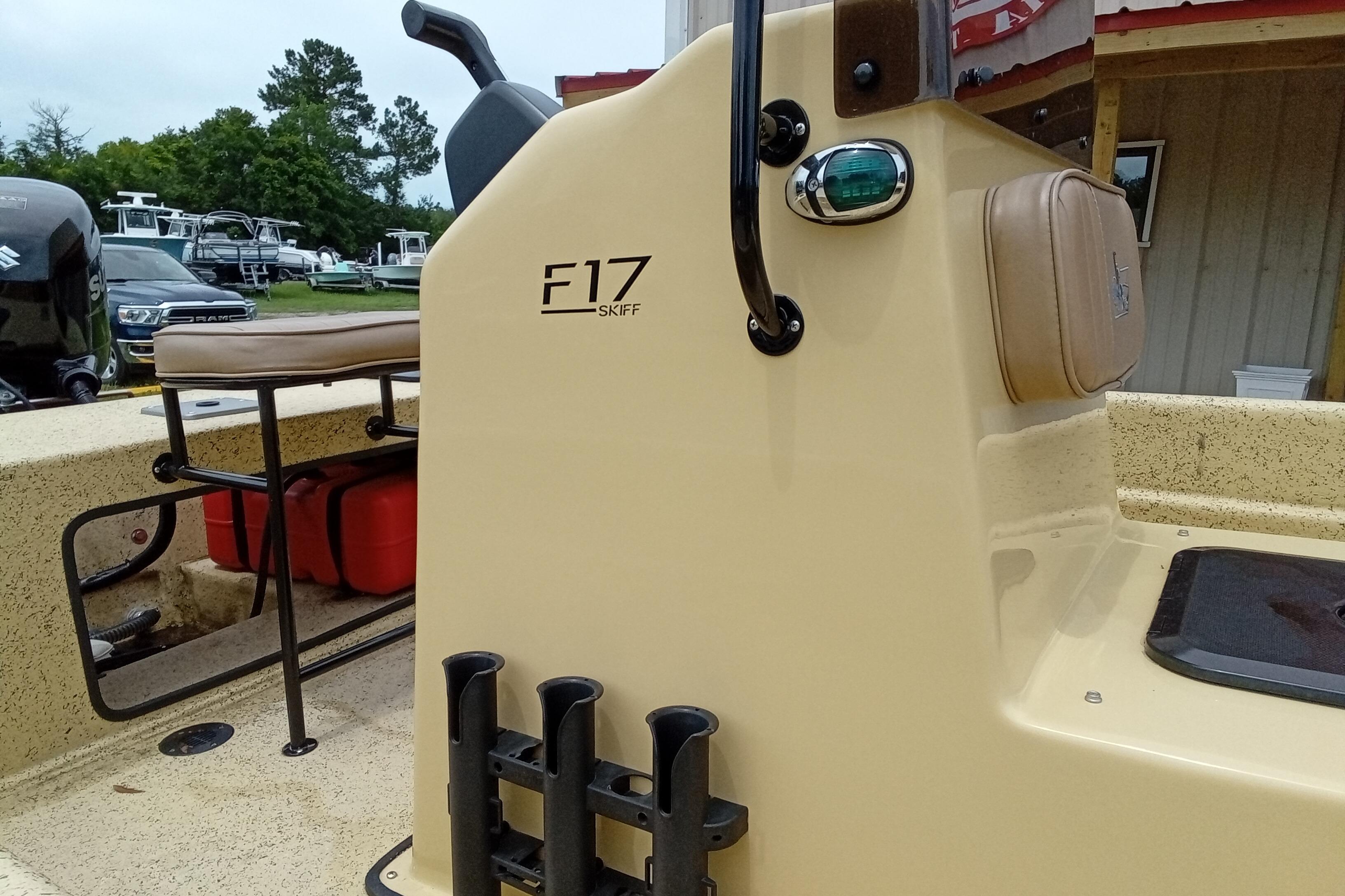 2025 Fibercraft F17 Skiff boat with beige console and seating, docked outdoors.